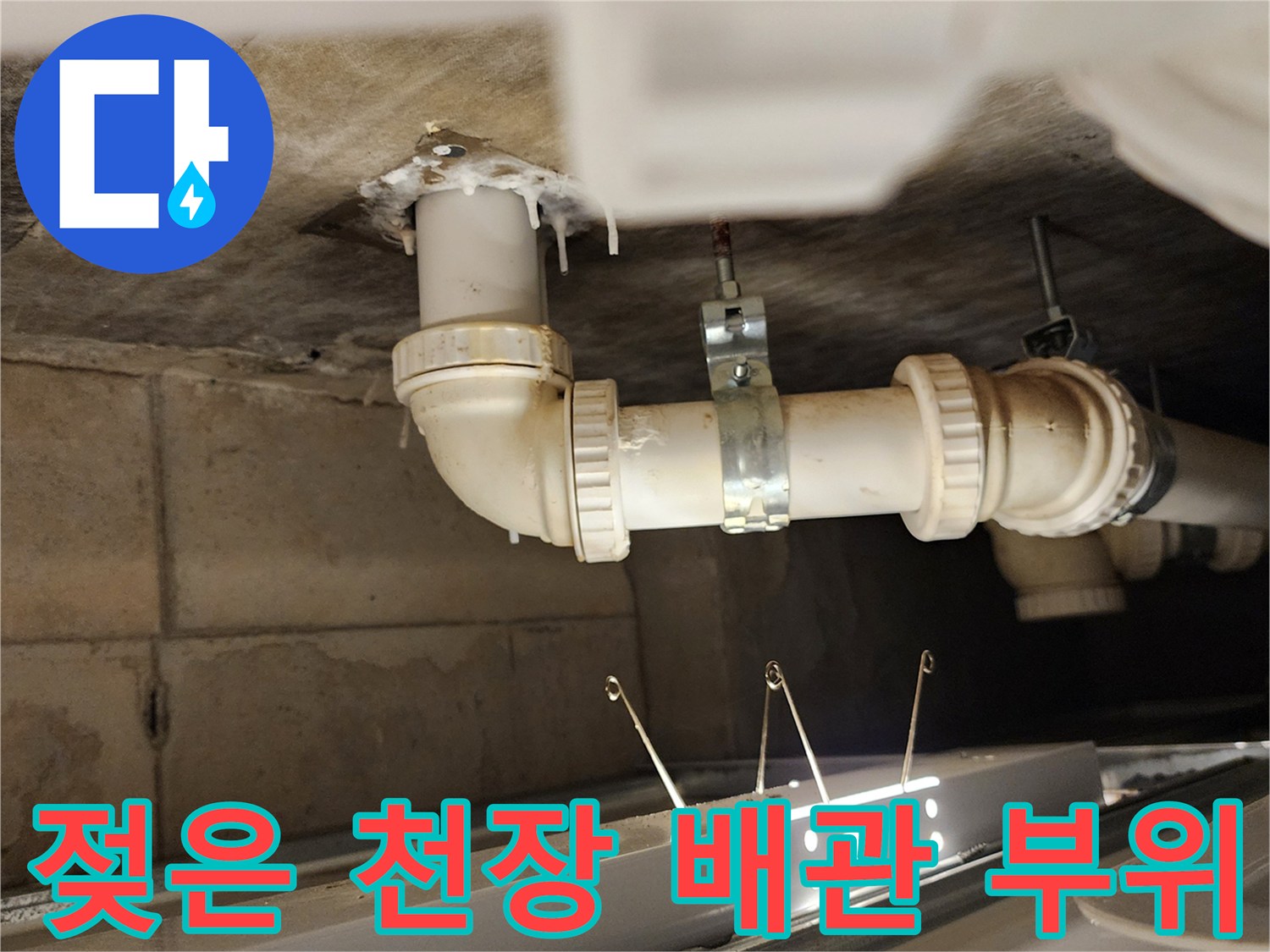 천장 슬라브와 배수 파이프 사이의 젖은 상태를 보여주는 사진