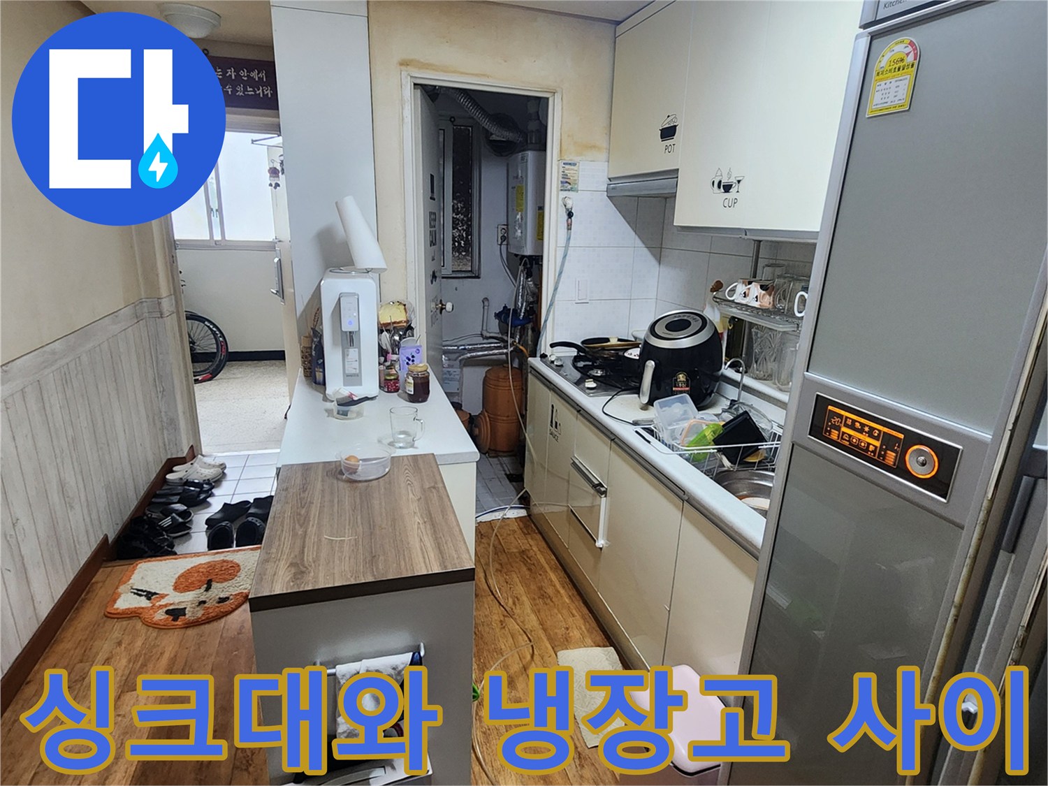 주방 싱크대와 냉장고가 배치된 공간의 모습