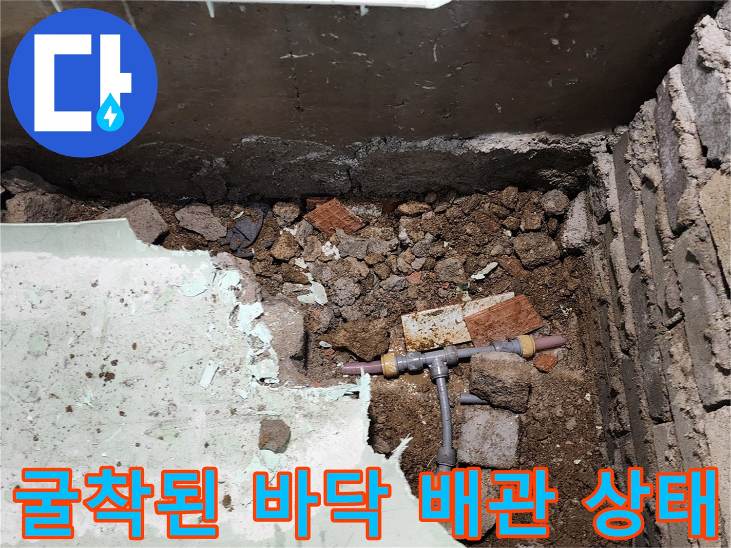 바닥 흙 속에서 발견된-누수가 진행 중인 T자형 배관 부속