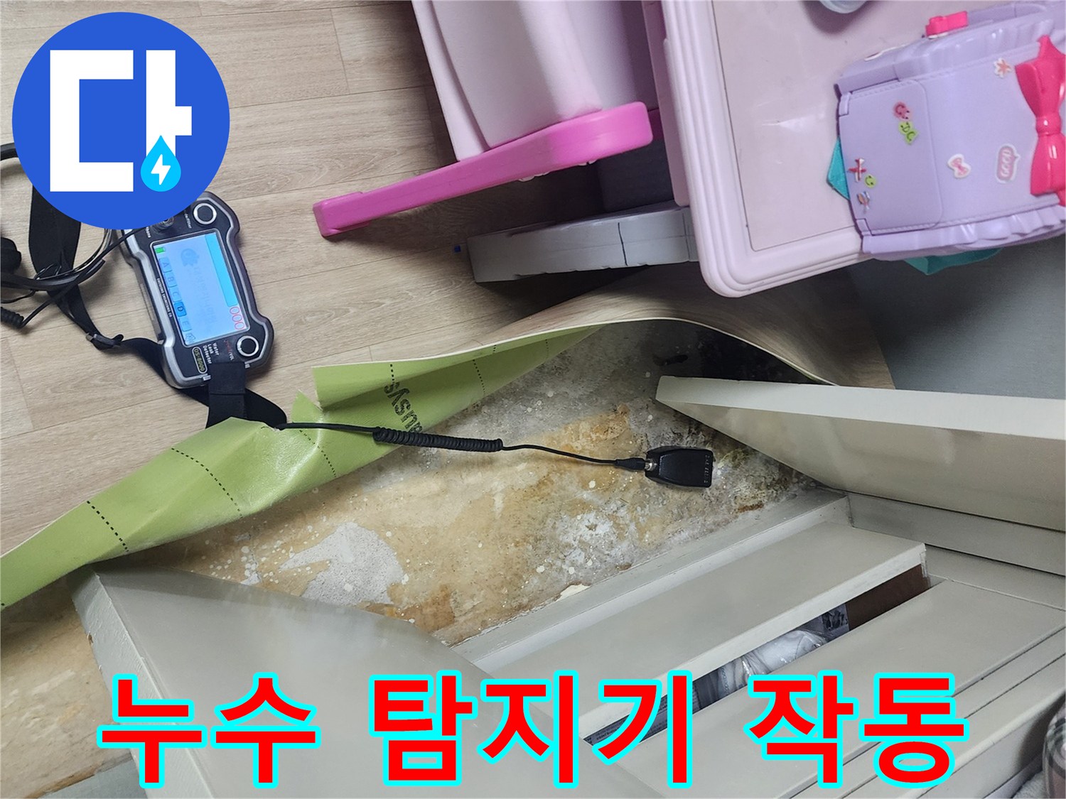 바닥 틈새 사이로 연결된 가스 탐지 장비를 통해 누수 지점을 찾는 현장입니다.