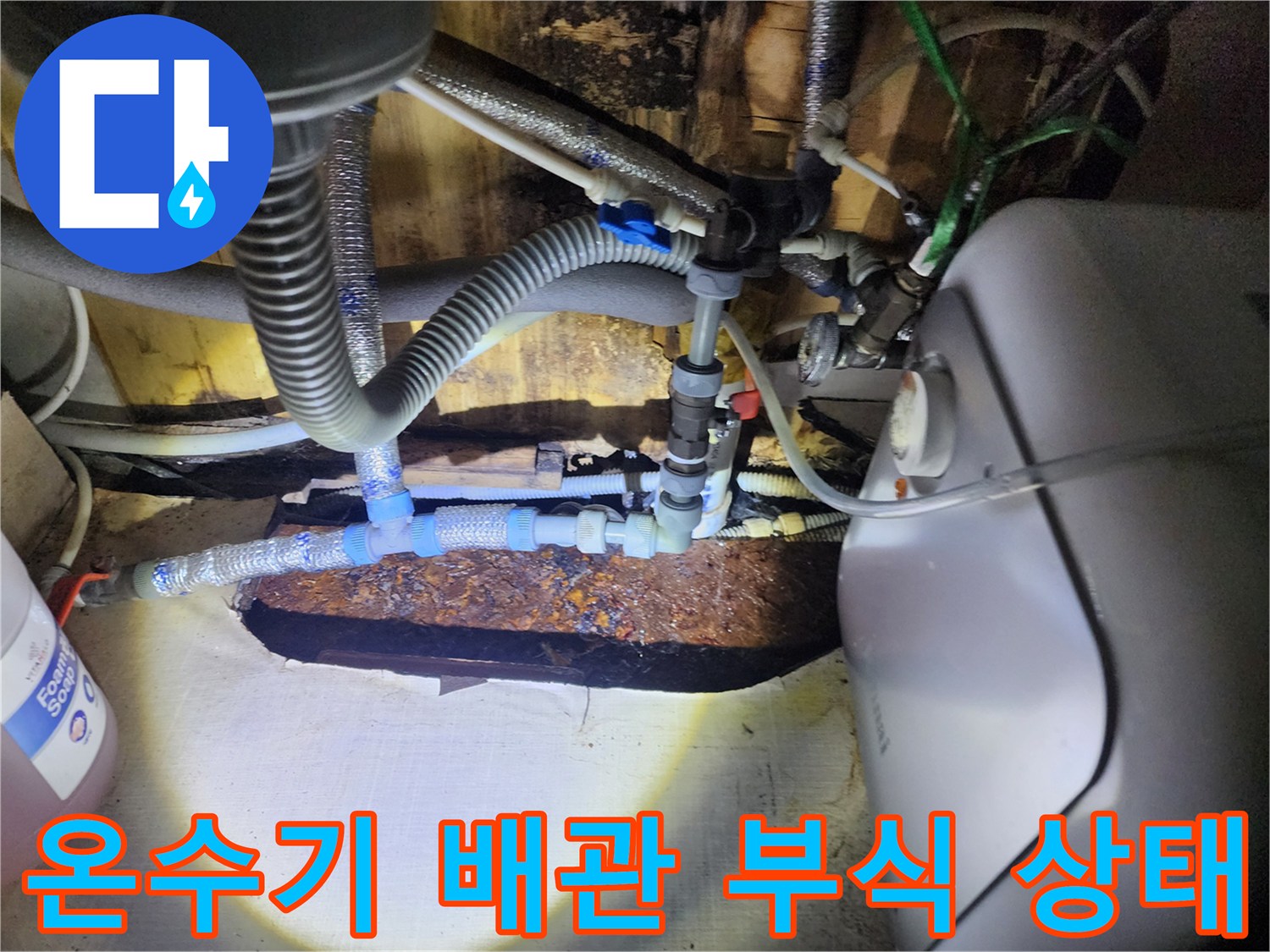 온수기 하단-노후된 배관 연결 부위의 심한 부식 상태를 보여주는 사진