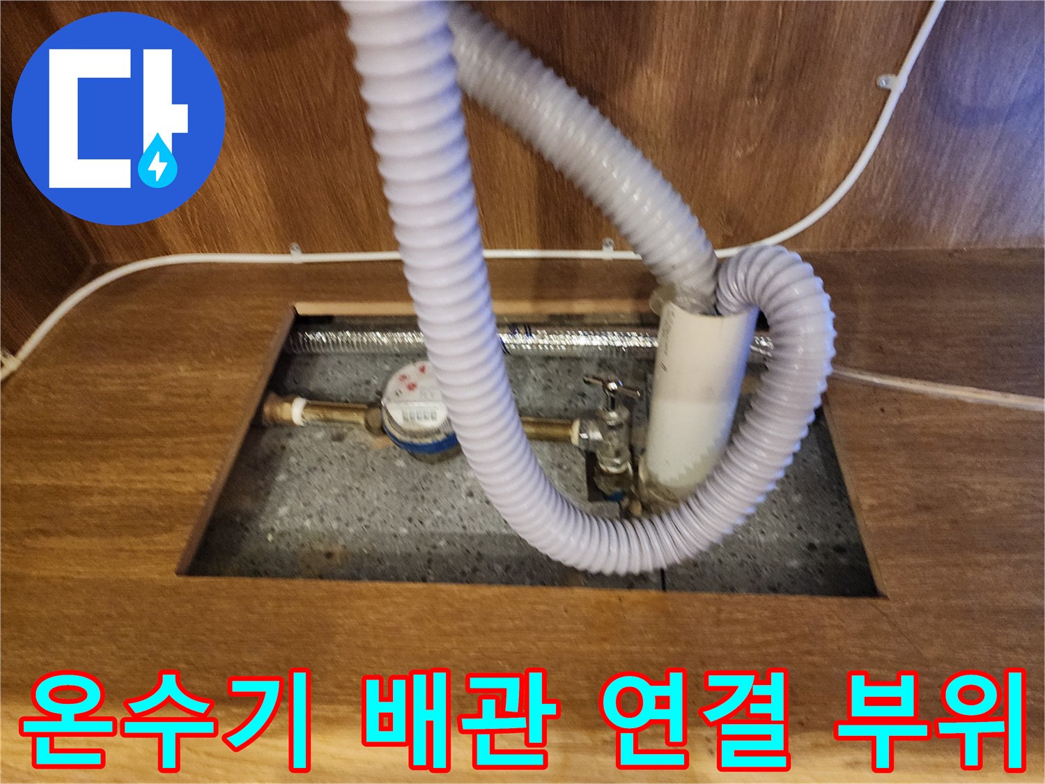 주방 하부장에 설치된 온수기와 주름 호스 연결 상태