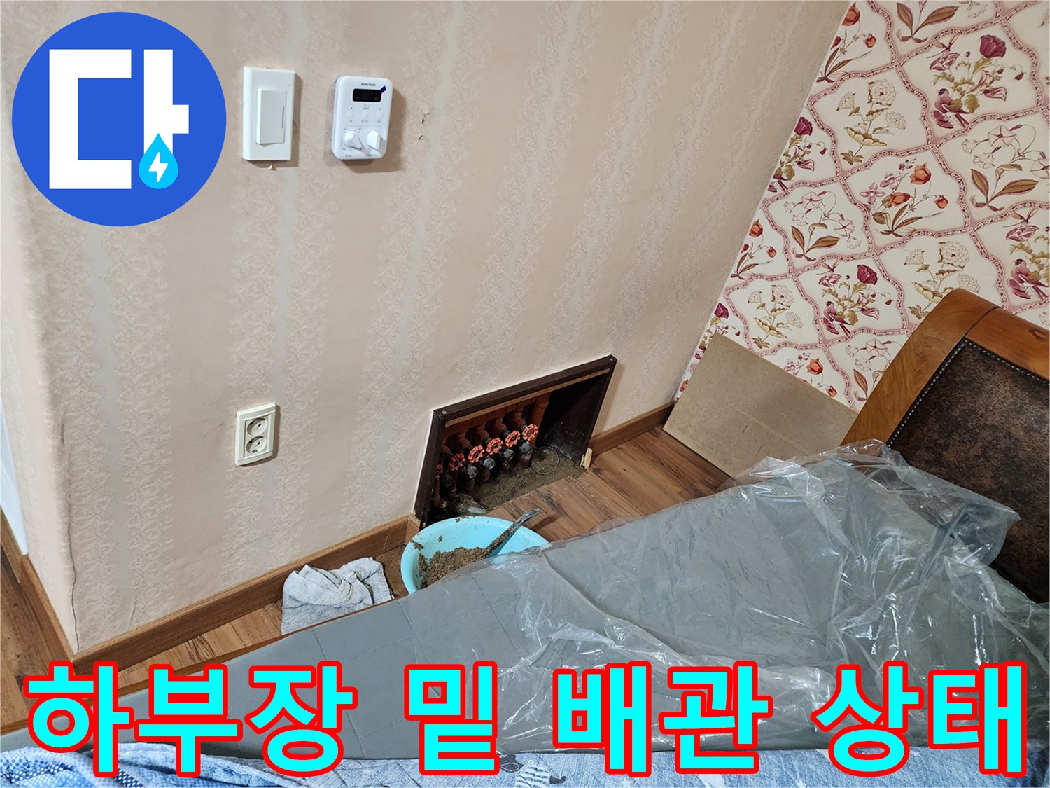 싱크대 아래 굴착된 부위의 오렌지색 보온재와 분배기 연결부