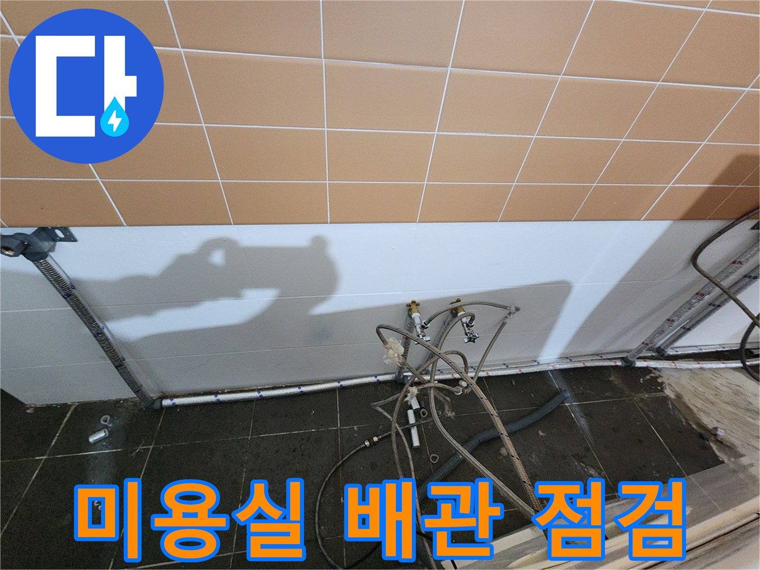 미용실 하부 샴푸대 배관과 연결 부속의 상태를 확인하는 모습