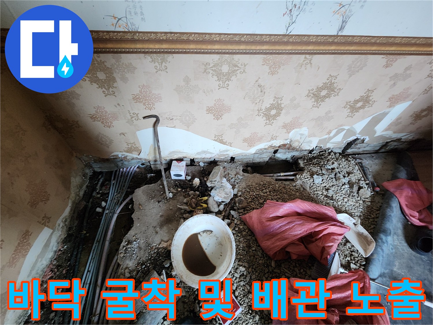 배관의 균열을 찾기 위해 바닥 타일 아래를 파헤친 현장 사진입니다.