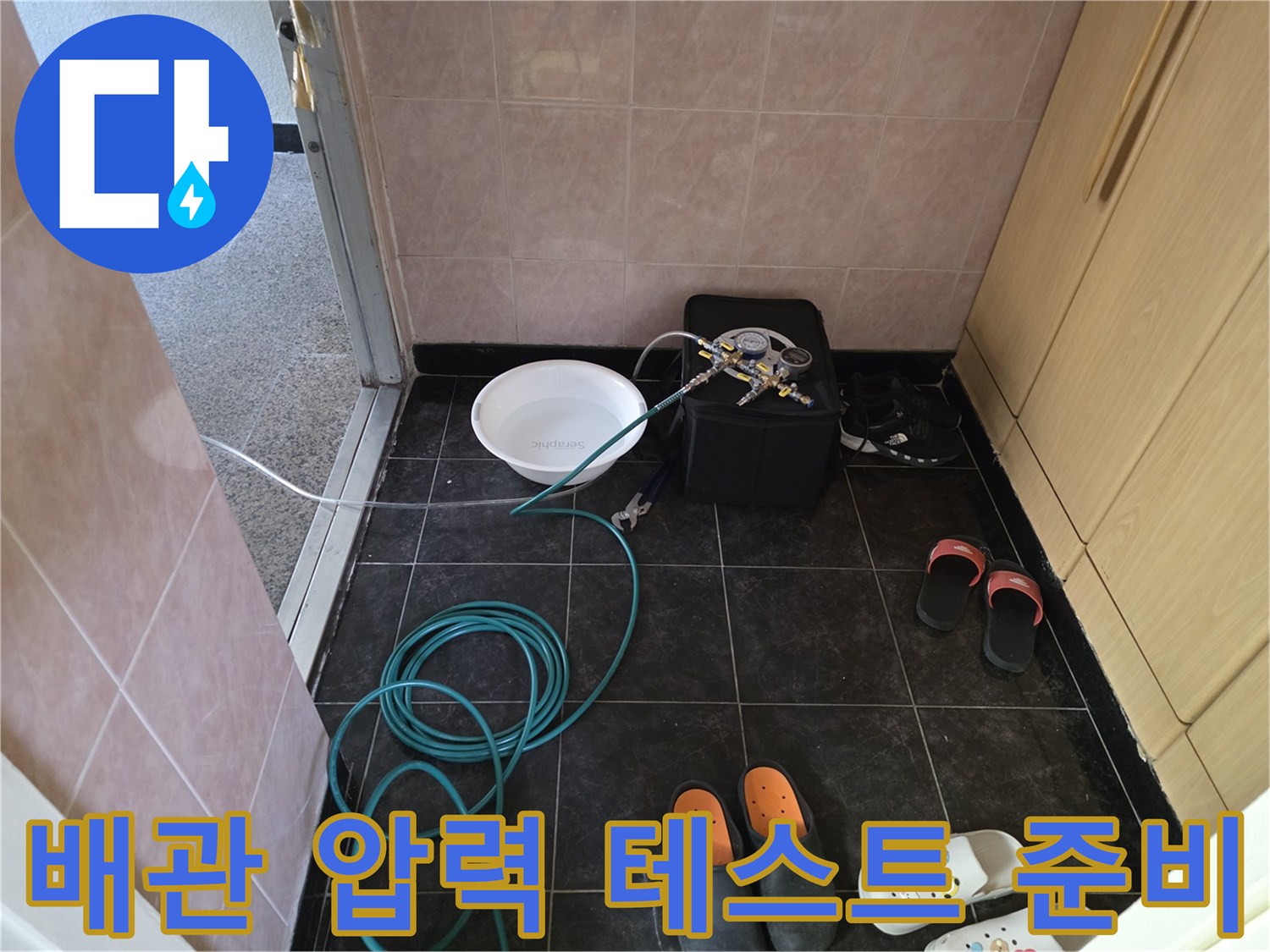 바닥 타일 위로 연결된 누수 탐지용 호스와 장비 세트