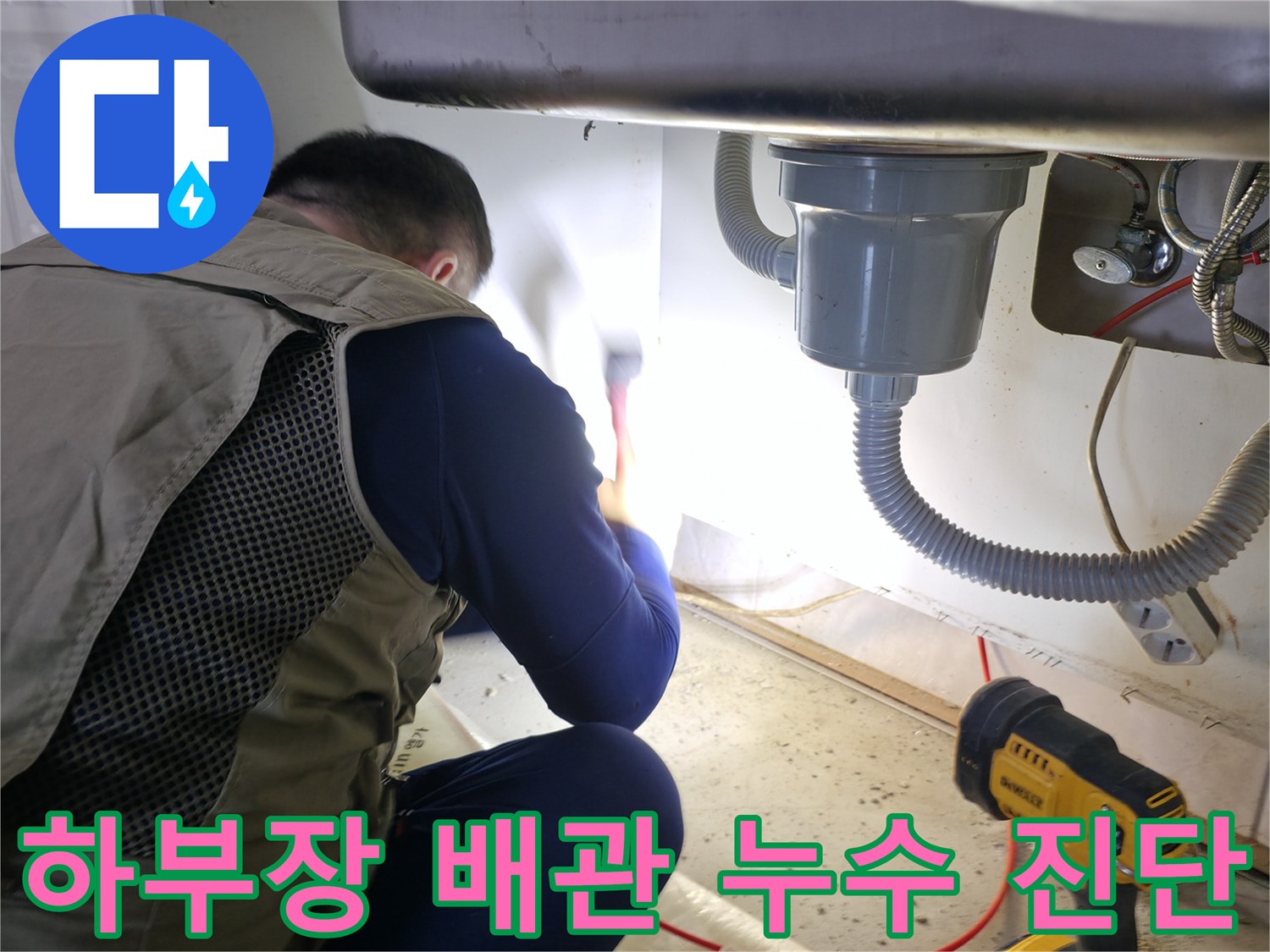 싱크대 하단 배수 호스와 수도 부속을 점검하는 엔지니어