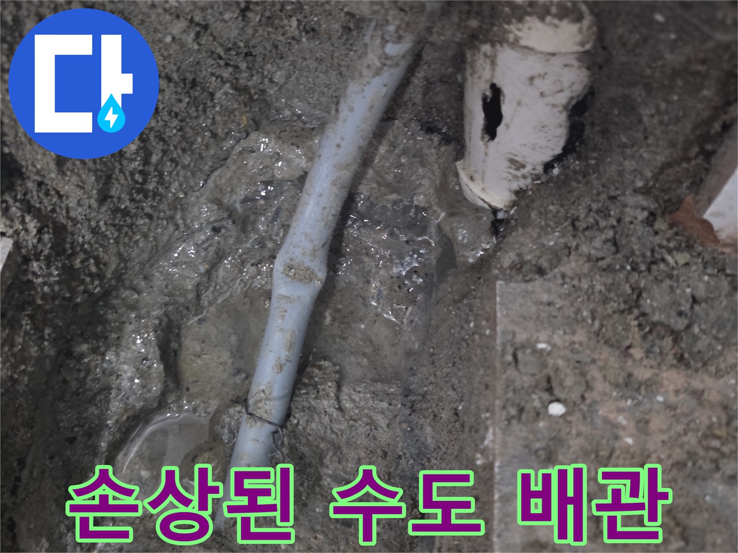 흙 속에 드러난 손상된 하얀색 배관과 누수 흔적