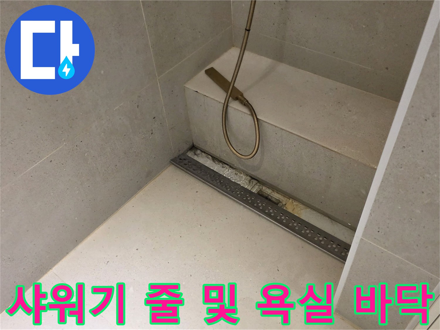 샤워기 헤드와 아래쪽 배수구가 보이는 욕실 내부