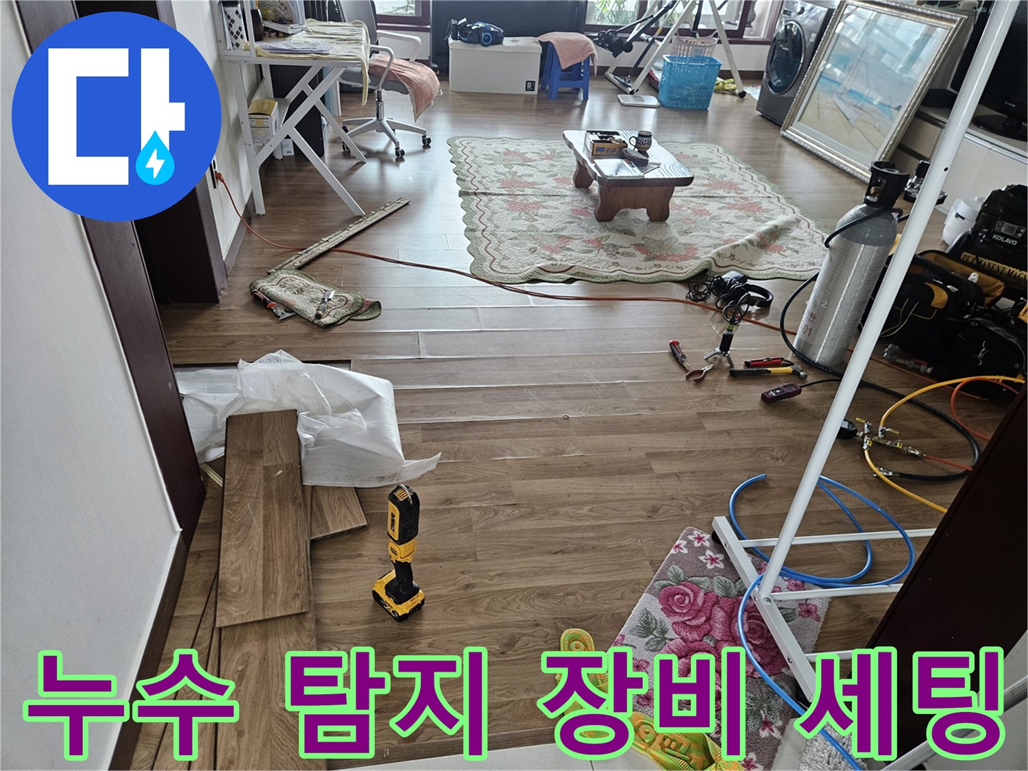 누수 지점을 찾기 위한 압력계와 탐지 도구들이 놓인 거실 바상