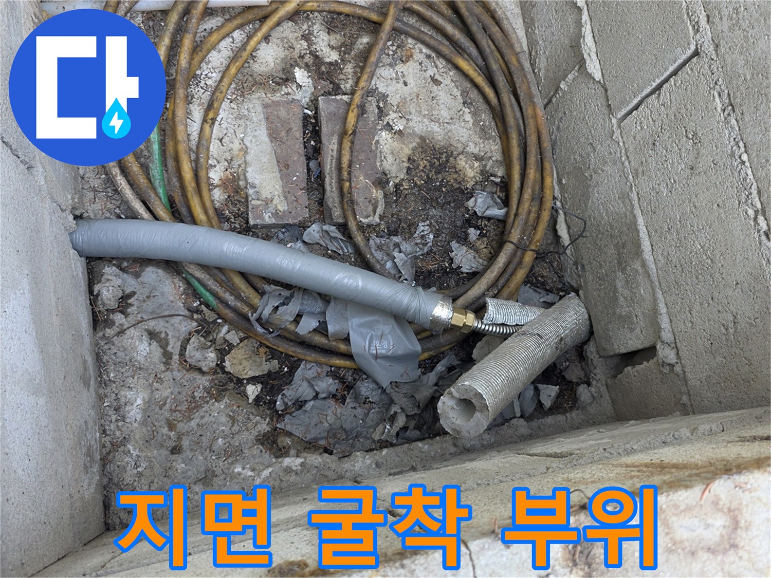 땅을 파낸 공간에-보이는 기존 배관과 연결 호스