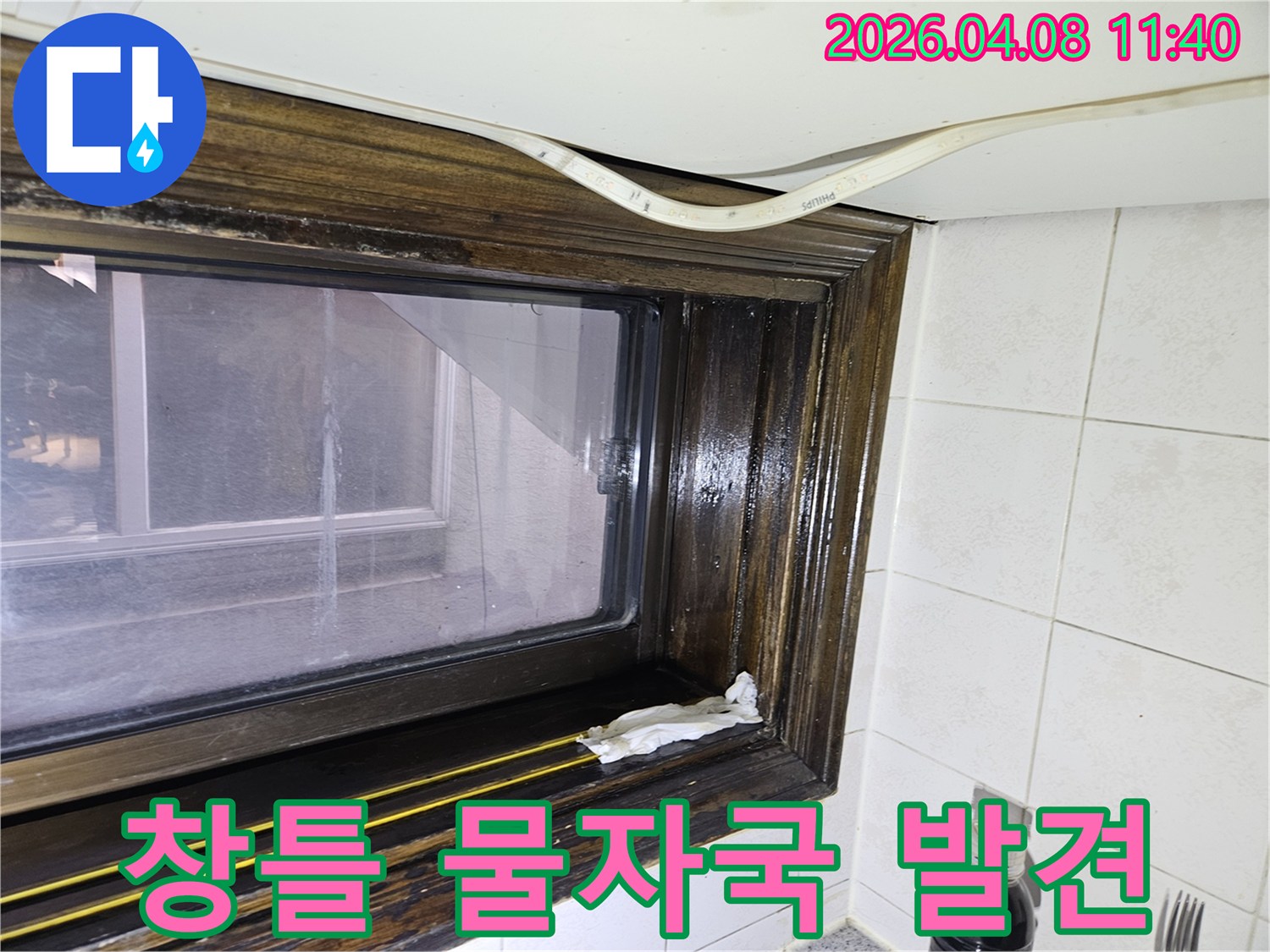 오래된 창틀에서 발견된 물샘-흔적을 보여주는 이미지로-누수 전문가가 현장을 점검하고 있습니다.