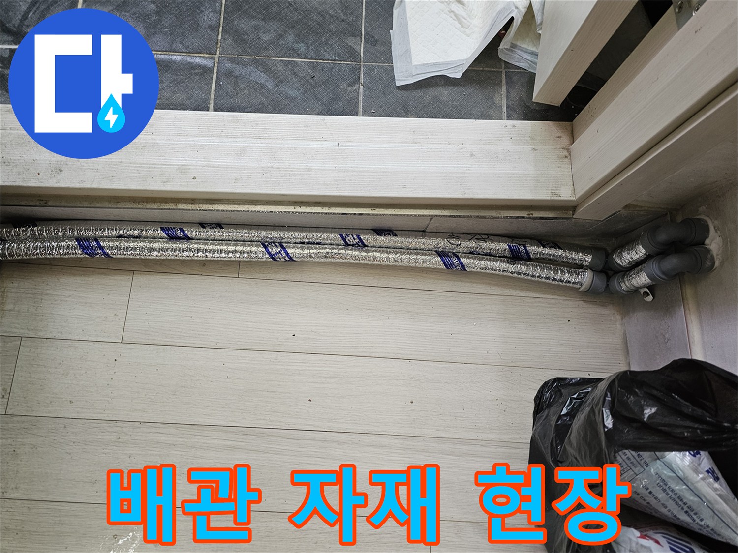 이 이미지는-남양주 진건읍 성심아트빌라-누수 배관 교체 작업을 위해-새로운 배관 자재가-현장에 배치되어 있는-모습을 보여줍니다