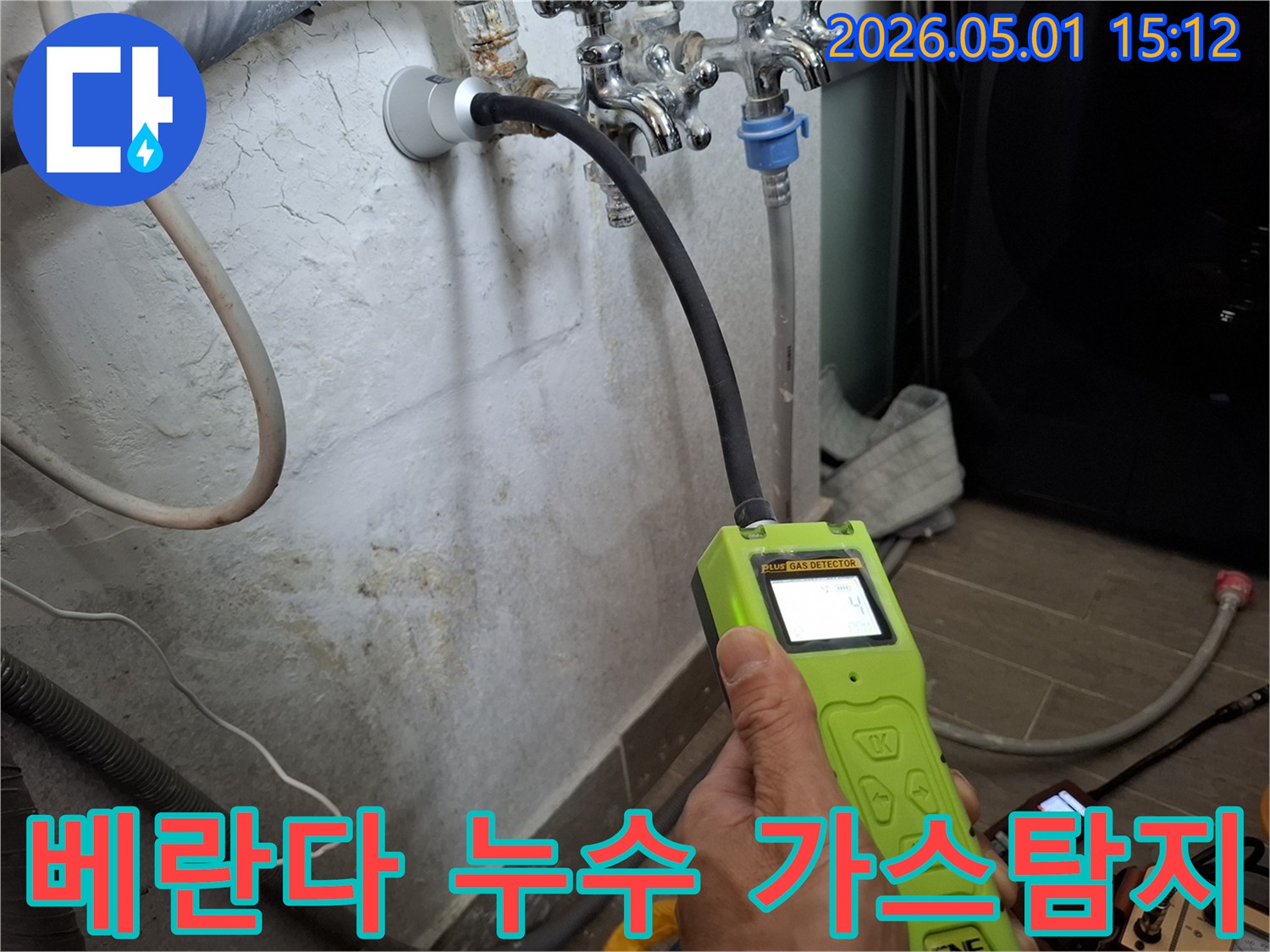 전문 엔지니어가-가스 누수탐지 장비를 사용하여-베란다 배관의 미세한 누수 지점을-정밀하게 확인하고 있는 모습입니다