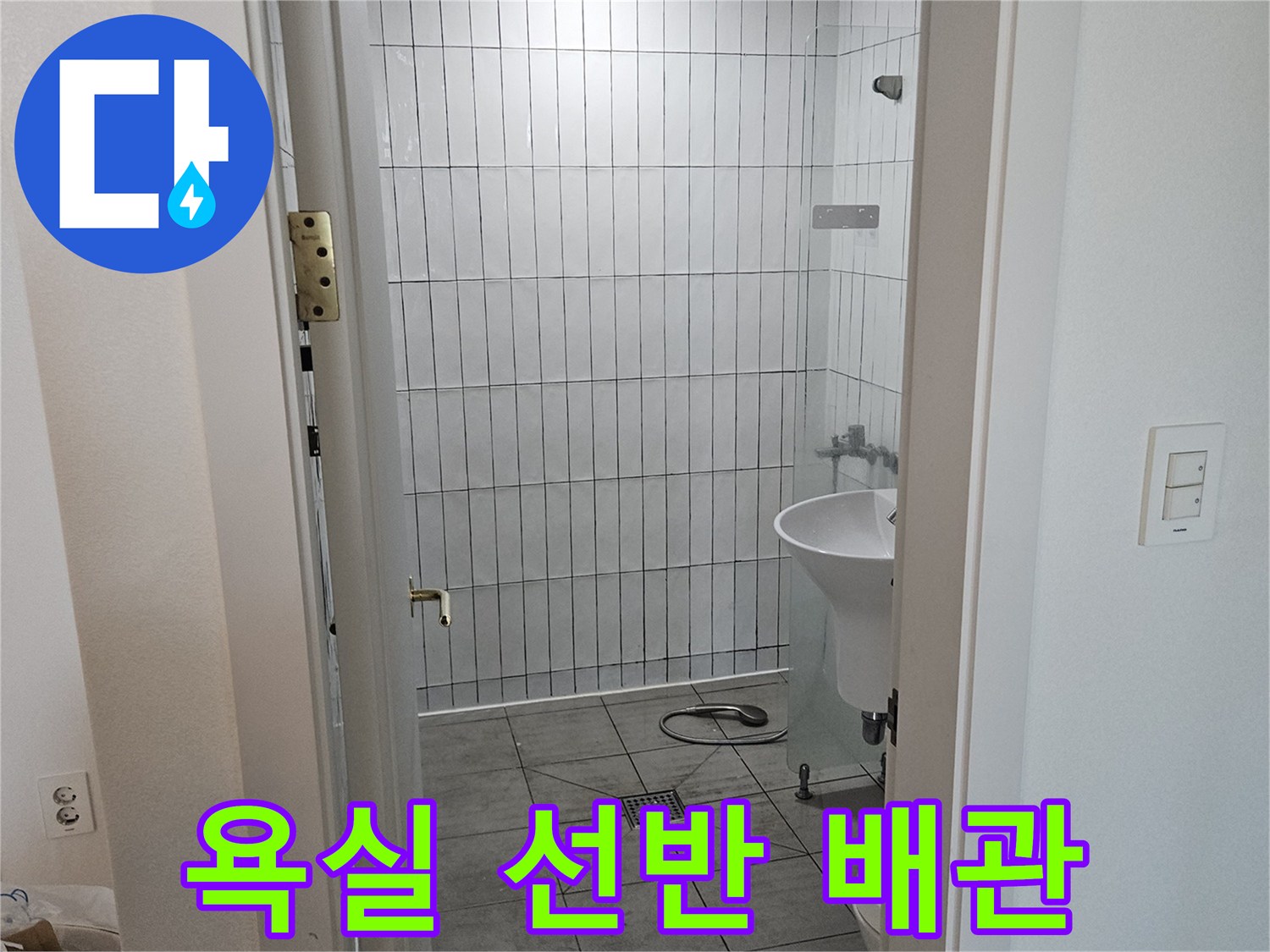화장실 내부의 하얀색 타일과 상단 선반 모습