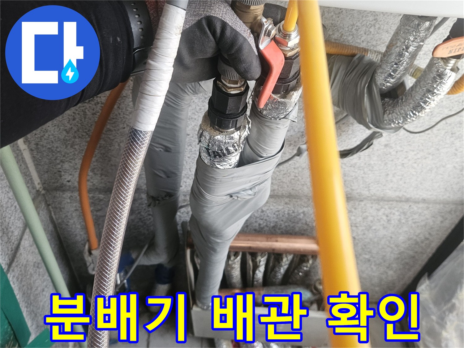 보일러 아래쪽 은색 보온재로 감싸진 여러 개의 배관들