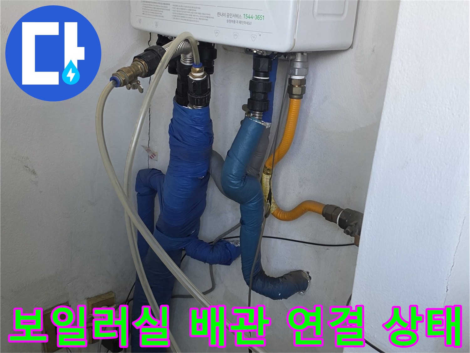 보일러 하단에 연결된 온수 및 직수 배관의 상세 사진