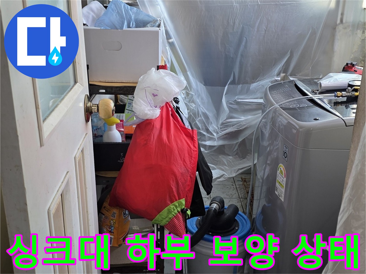 누수 점검을 위해 비닐로 덮여 있는 싱크대 밑 공간