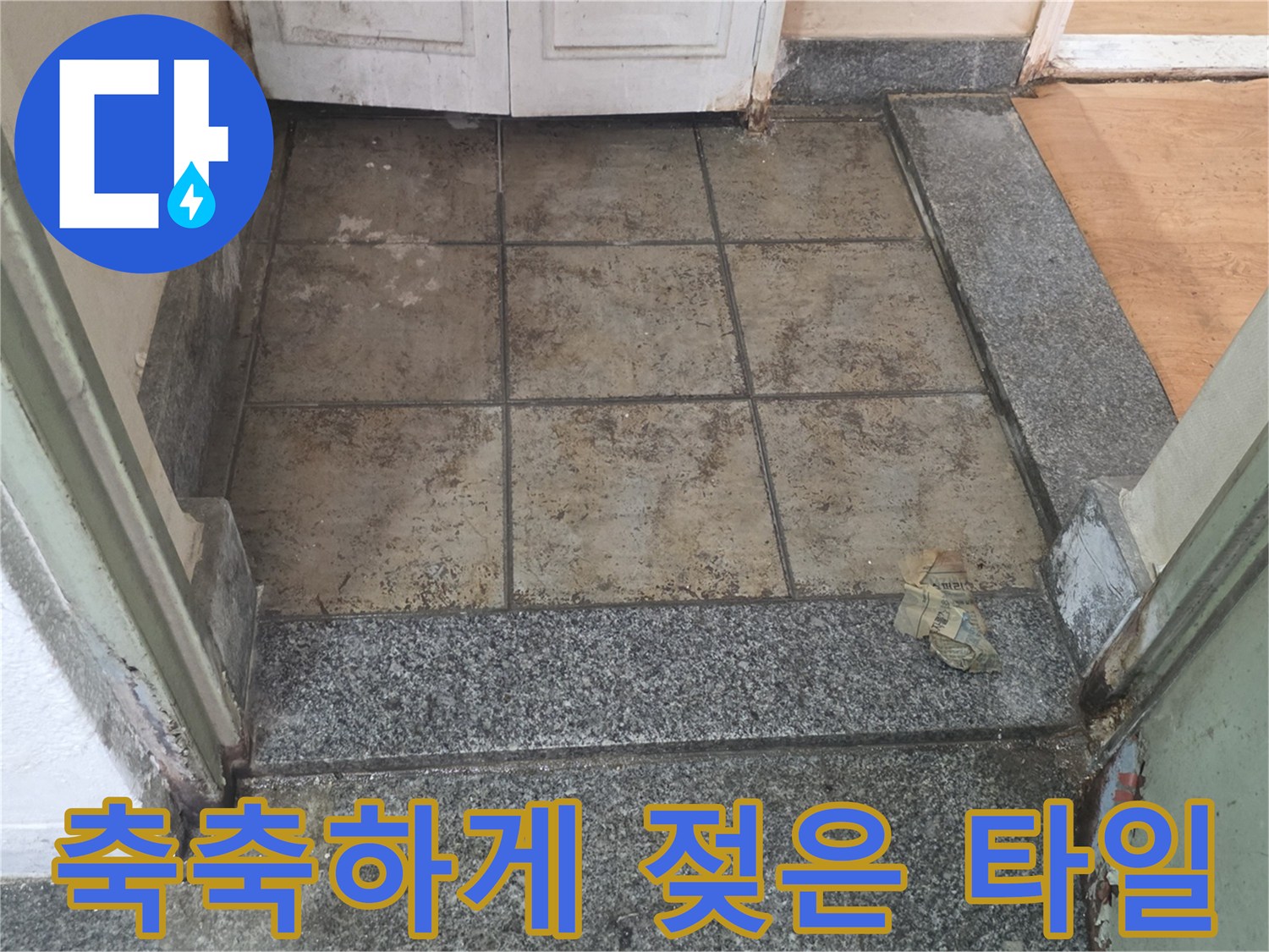 현관 입구 타일의 변색된 부분과 습기 머금은 상태