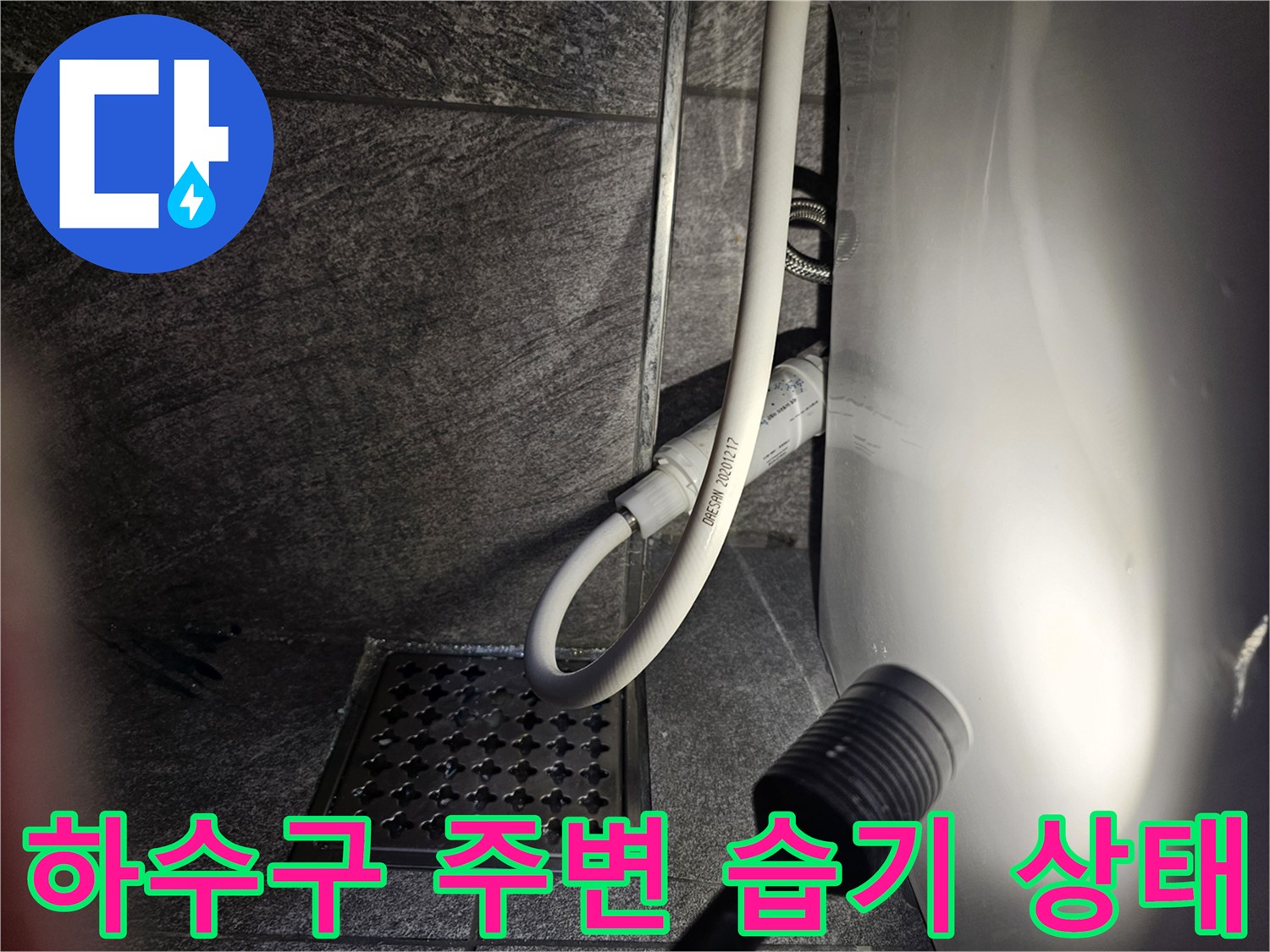변기 탈거 후 하수구 덮개와 급수 호스가 보이는 현장