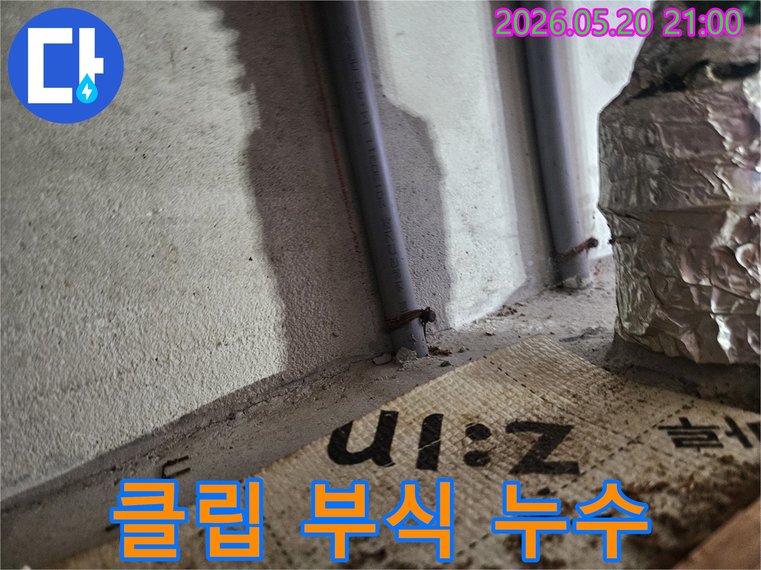 벽에 고정된 배관의 클립이- 부식되어 주변으로 물기가 스며든- 현장 사진입니다