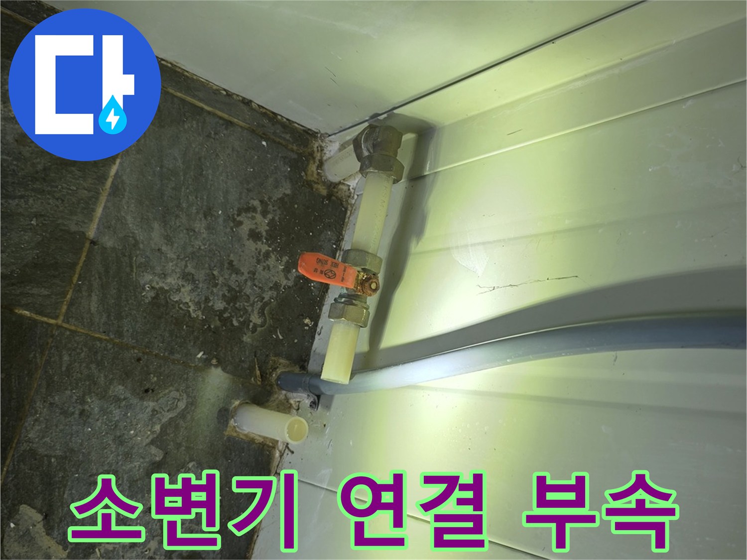 소변기 하단부의 노후된 배관과 밸브 장치 모습입니다.