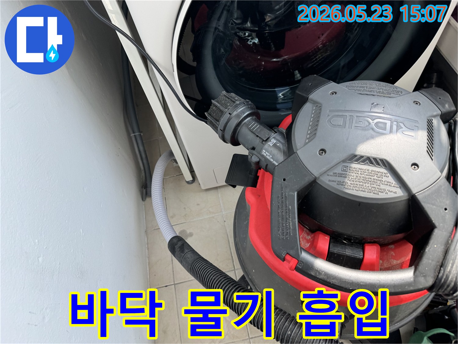 누수로 젖은-세탁기 주변 바닥의 물기를-전문 흡입기로 제거하여-쾌적한 환경을 만드는 작업입니다