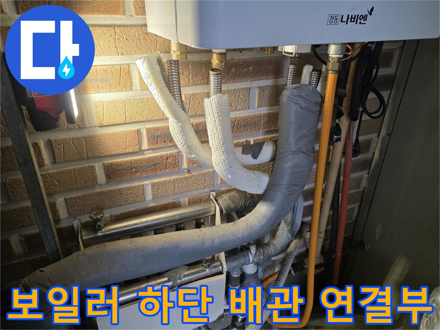 벽돌 벽면에 설치된 보일러와 분배기 배관들