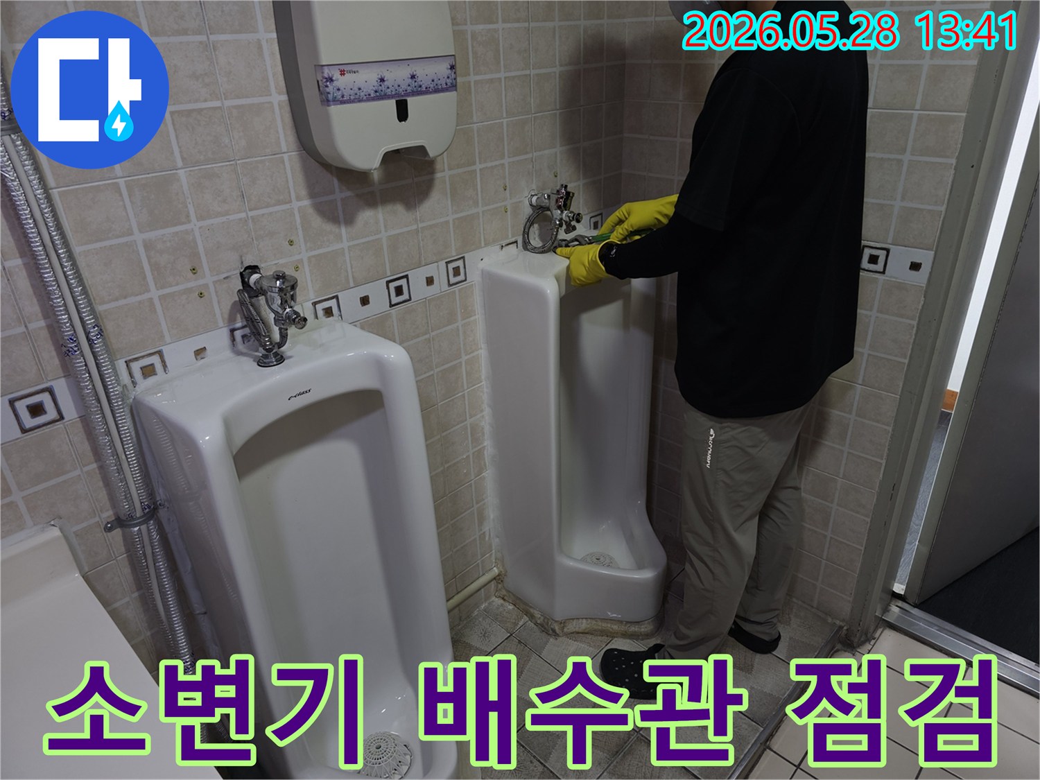 누수 전문 엔지니어가-소변기 배수관의-누수 여부를-세심하게 점검하고 있습니다