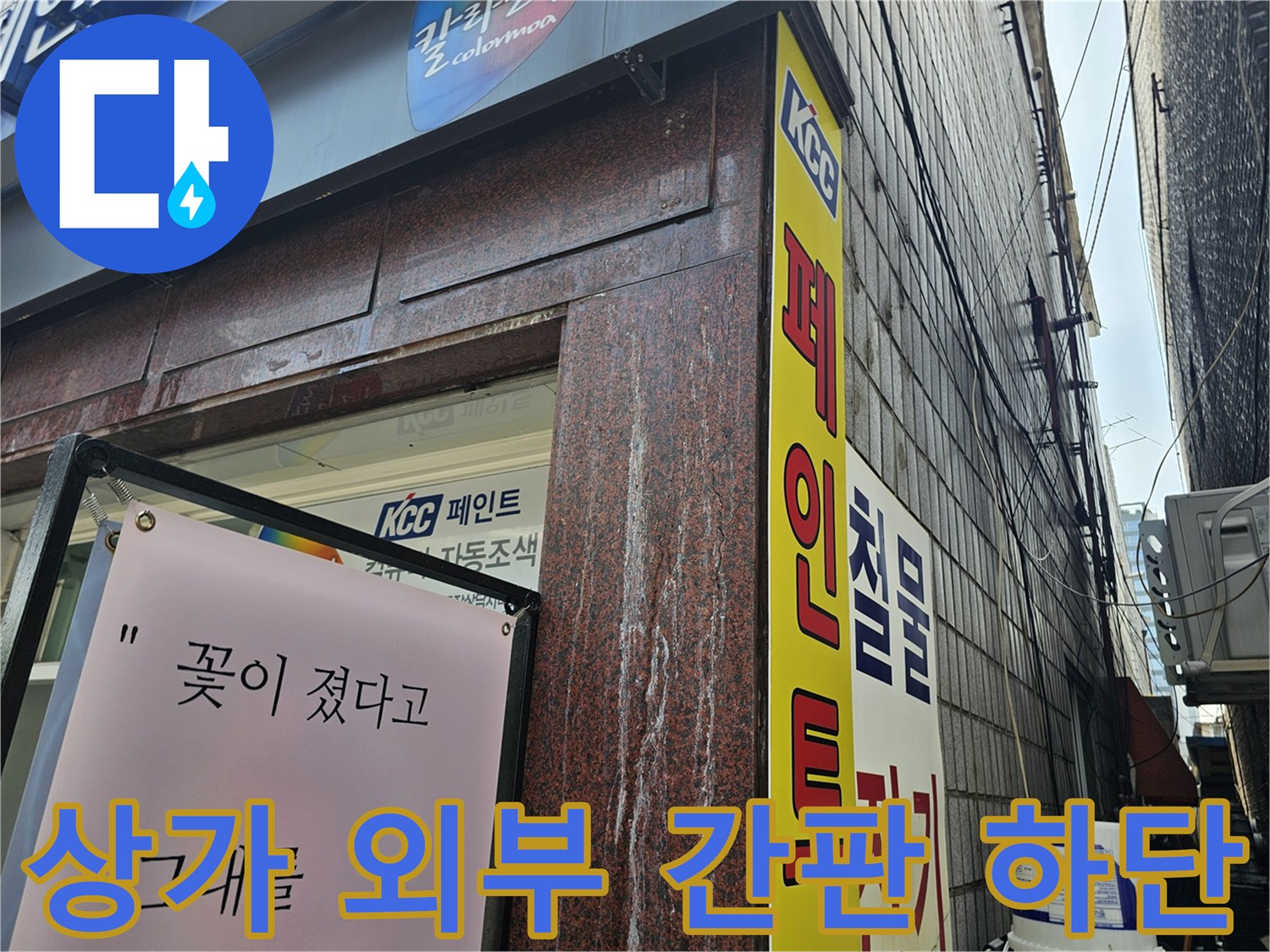 상가 건물 외벽의 페인트 광고판과 벽면 구조