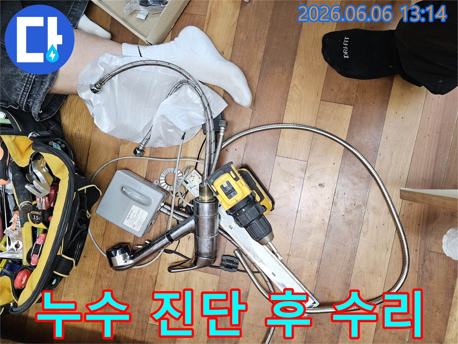 싱크대 누수 문제를 해결하기 위한-교체용 수도꼭지-연결 배관-그리고 작업용 드릴이 보이는 현장입니다.