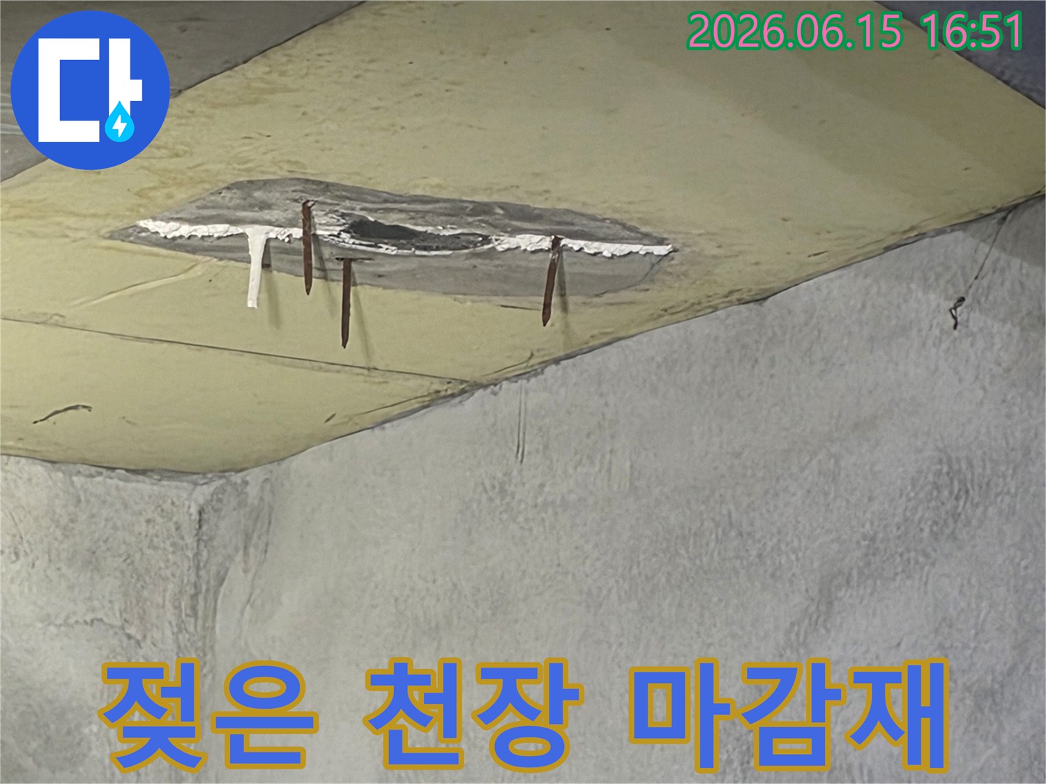 천장에서 물이 새어-마감재가 떨어져 나갔고-녹슨 철근이 노출된-누수 현장 사진입니다