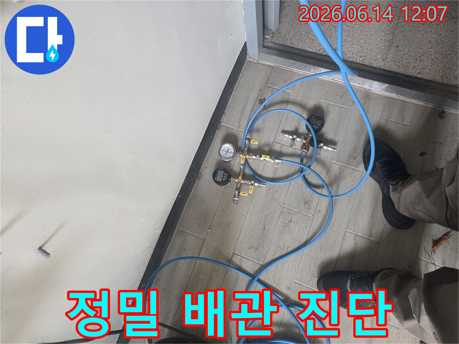 누수 탐지 전문가가 배관에 압력 테스트 장비를 연결하여-누수 지점을 정확하게 파악하는 현장 모습입니다.