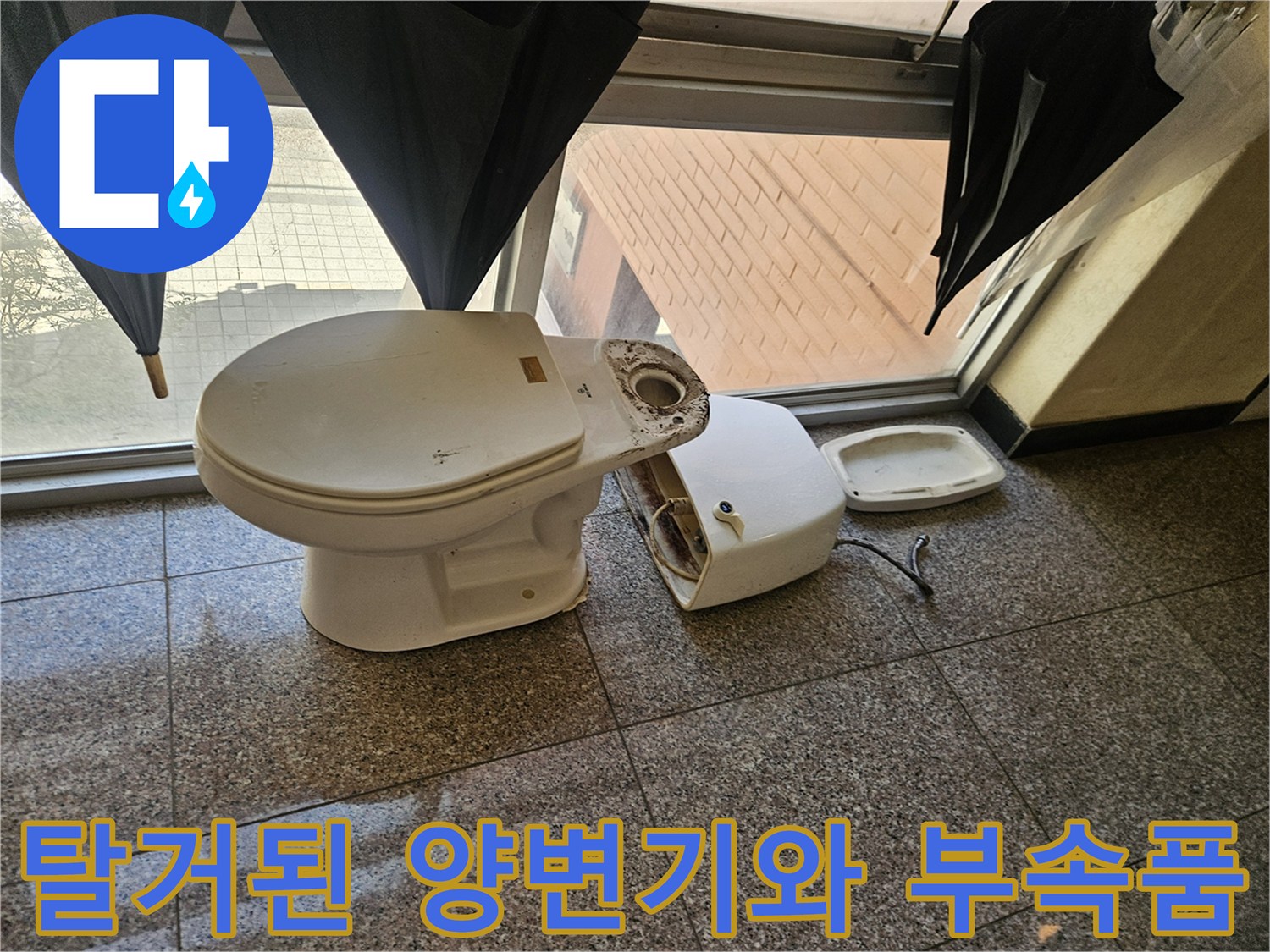 화장실 바닥에 놓인 탈거된 양변기와 변기 부속품 상태