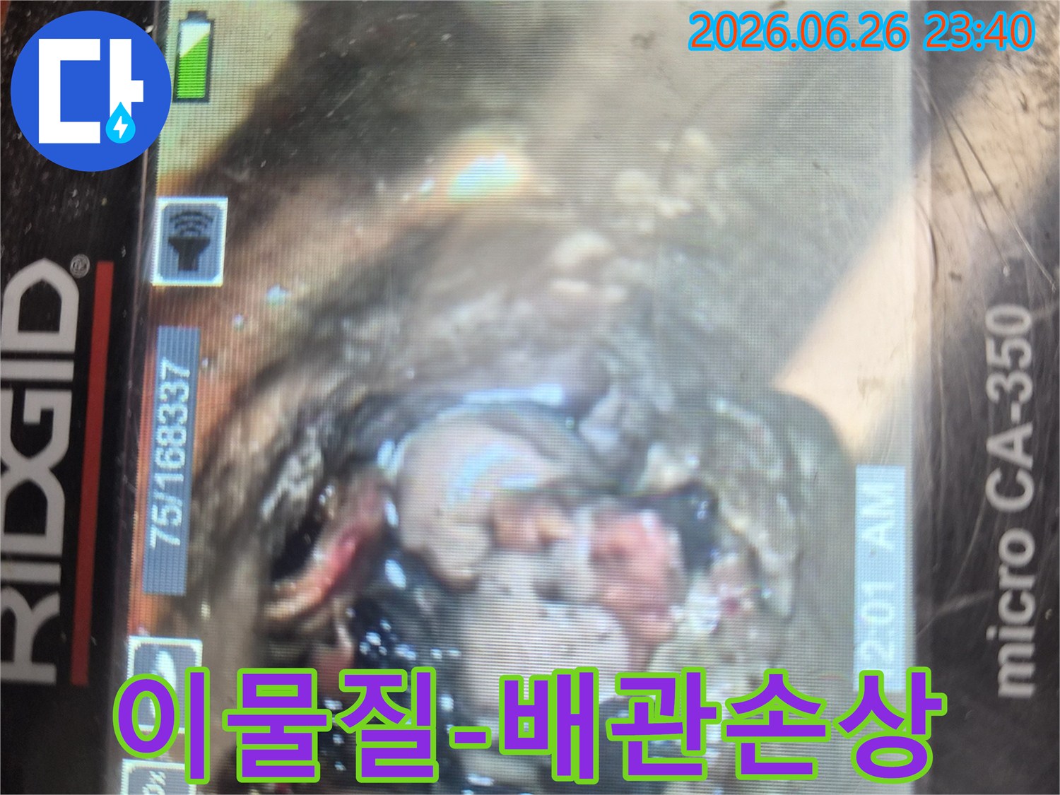 하수구 역류의 원인을 찾기 위해-내시경 카메라로 촬영한-배관 내부의-심각한 이물질과-손상 상태를 보여주는 이미지입니다.