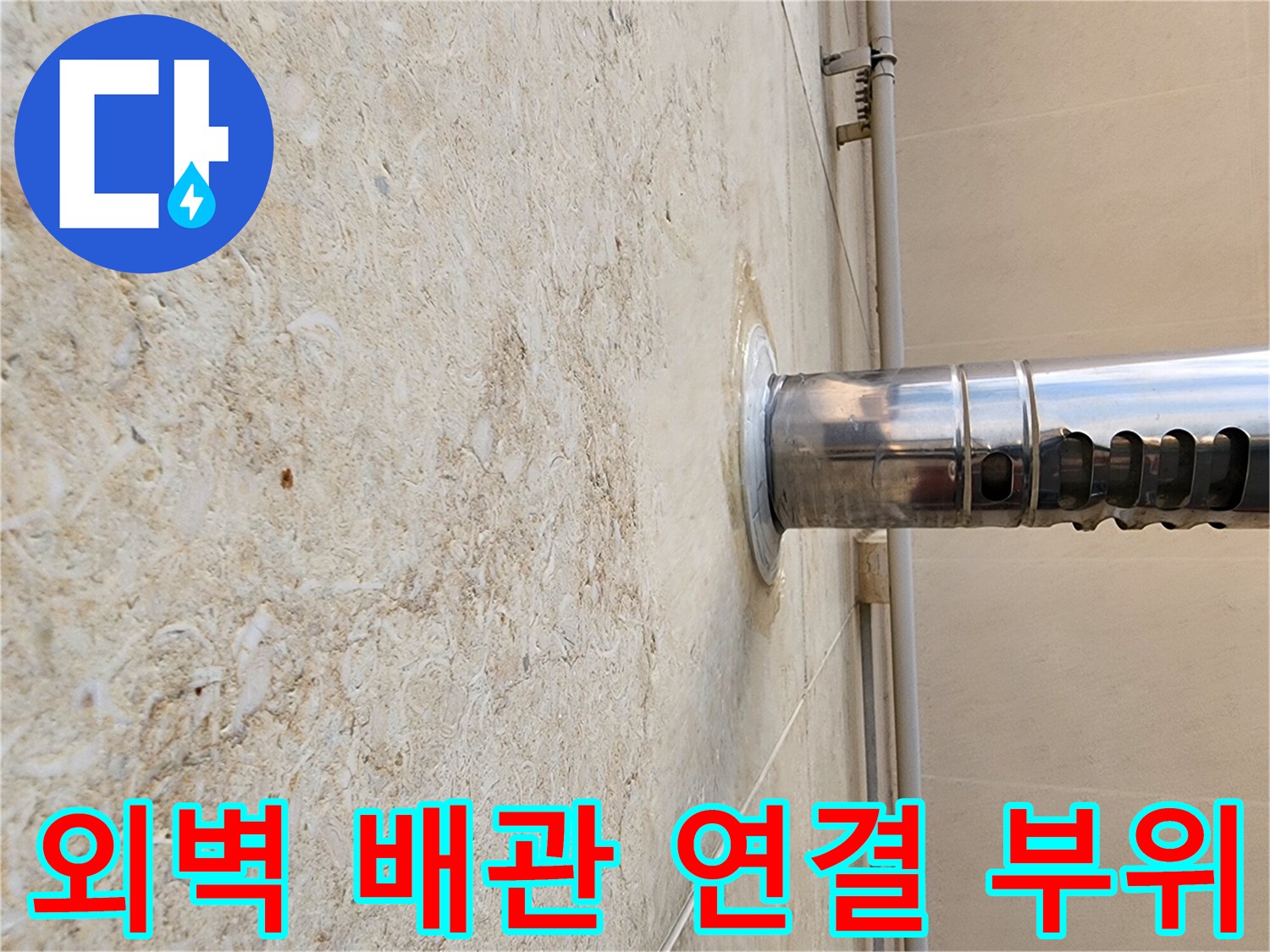 석재 마감재와 스테인리스 관 사이의 틈새를 근접 촬영한 사진