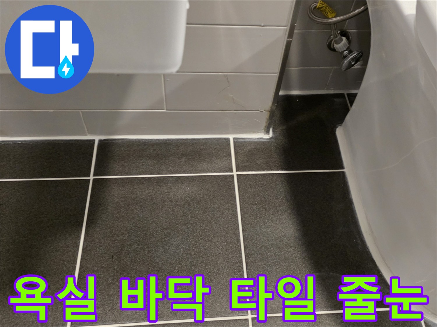 세면대 아래쪽 어두운 회색 타일과 벽면 접촉 부위