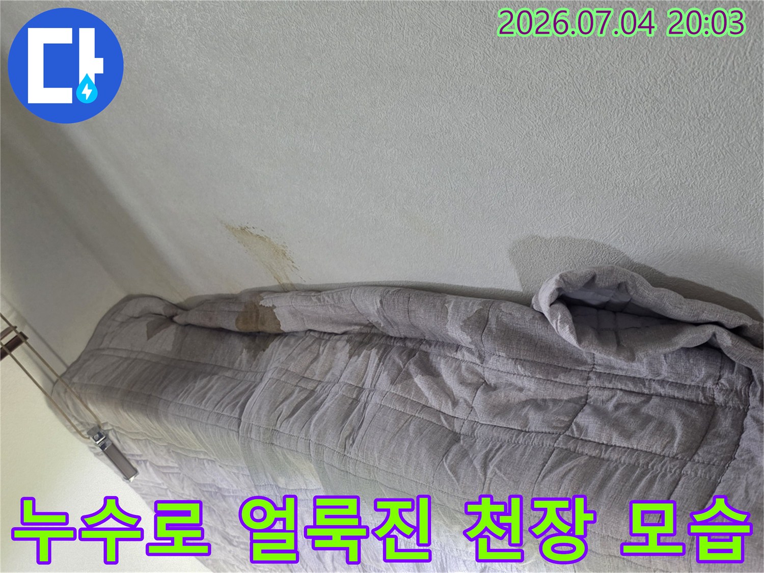 천장 누수 흔적과 임시 보양재가 덮여 있는 피해 상황