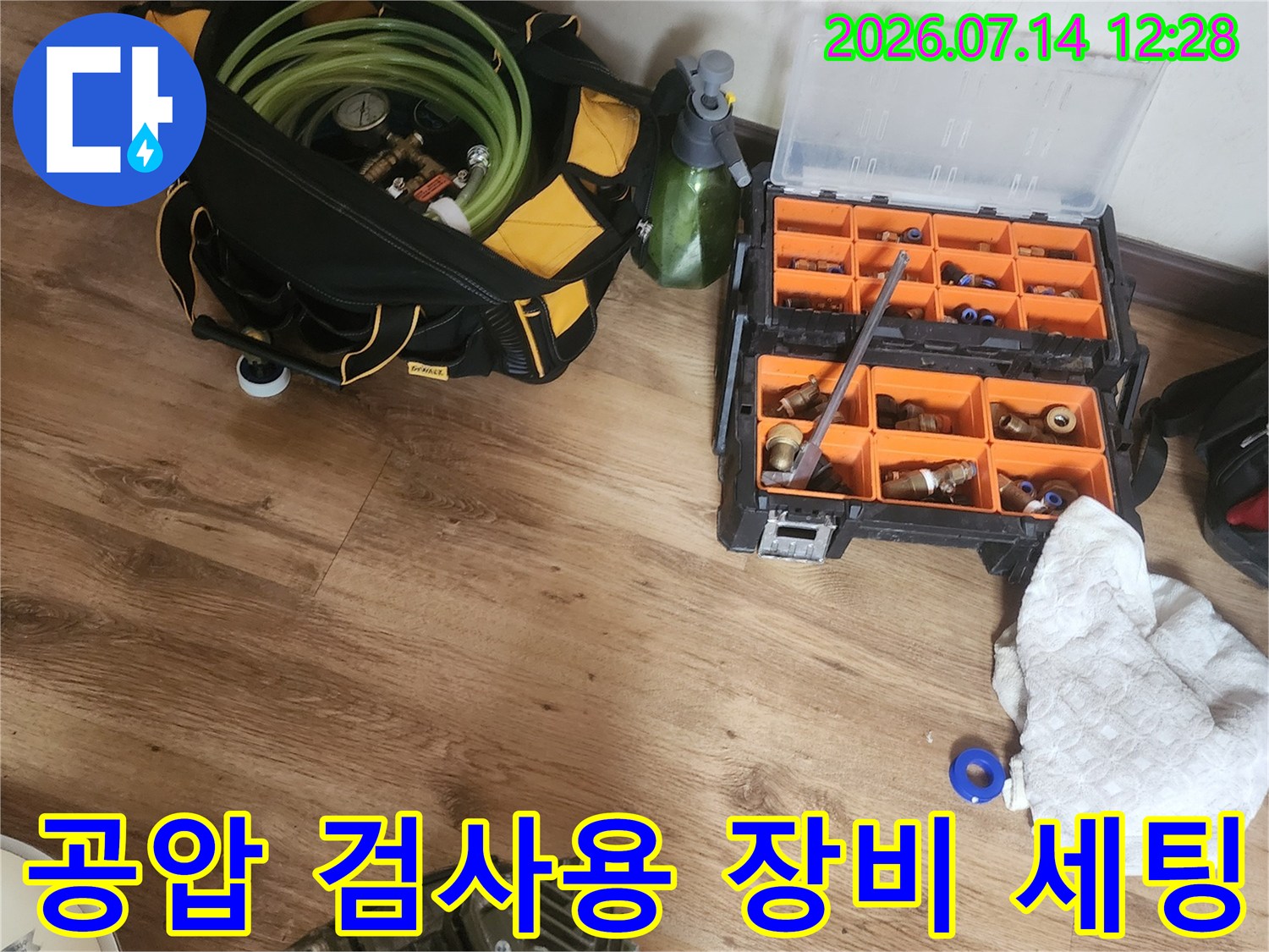 노란색 호스가 연결된 공압 계측기와 정돈된 작업용 도구 함체