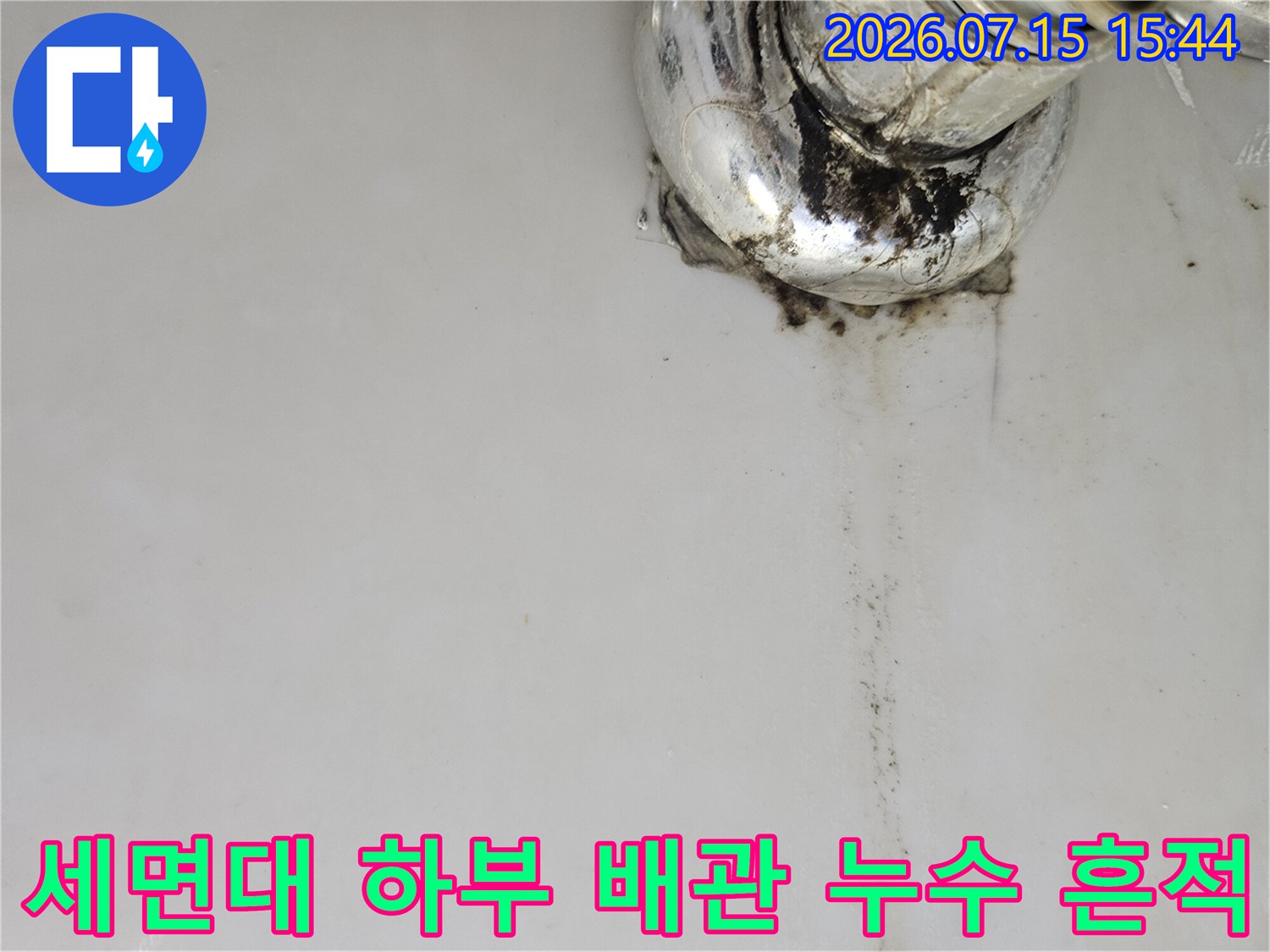 세면대 아래쪽 노후된 배관 연결 부위와 물이 흘러내린 자국