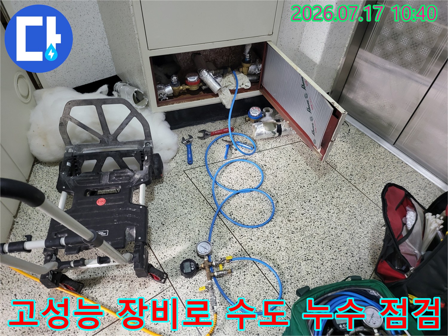 다수의 파란색 호스와 압력계가 연결된 상태에서 정밀하게 배관을 테스트하는 모습