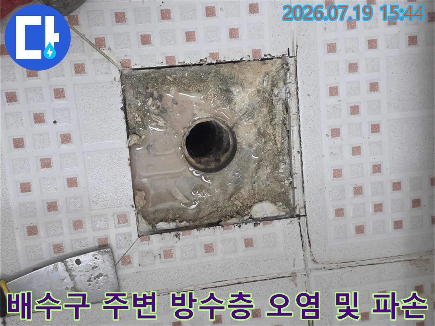 욕실 배수구의 타일 마감 부분이 떨어져 나가고 내부가 부식된 모습-누수 지점 사진
