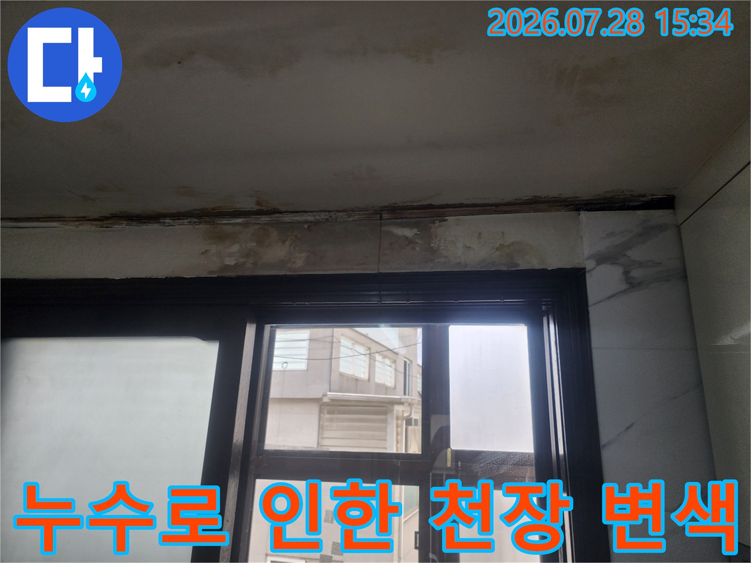 창문 위쪽 공간에 발생한 누수 얼룩과 오염된 벽면의 모습
