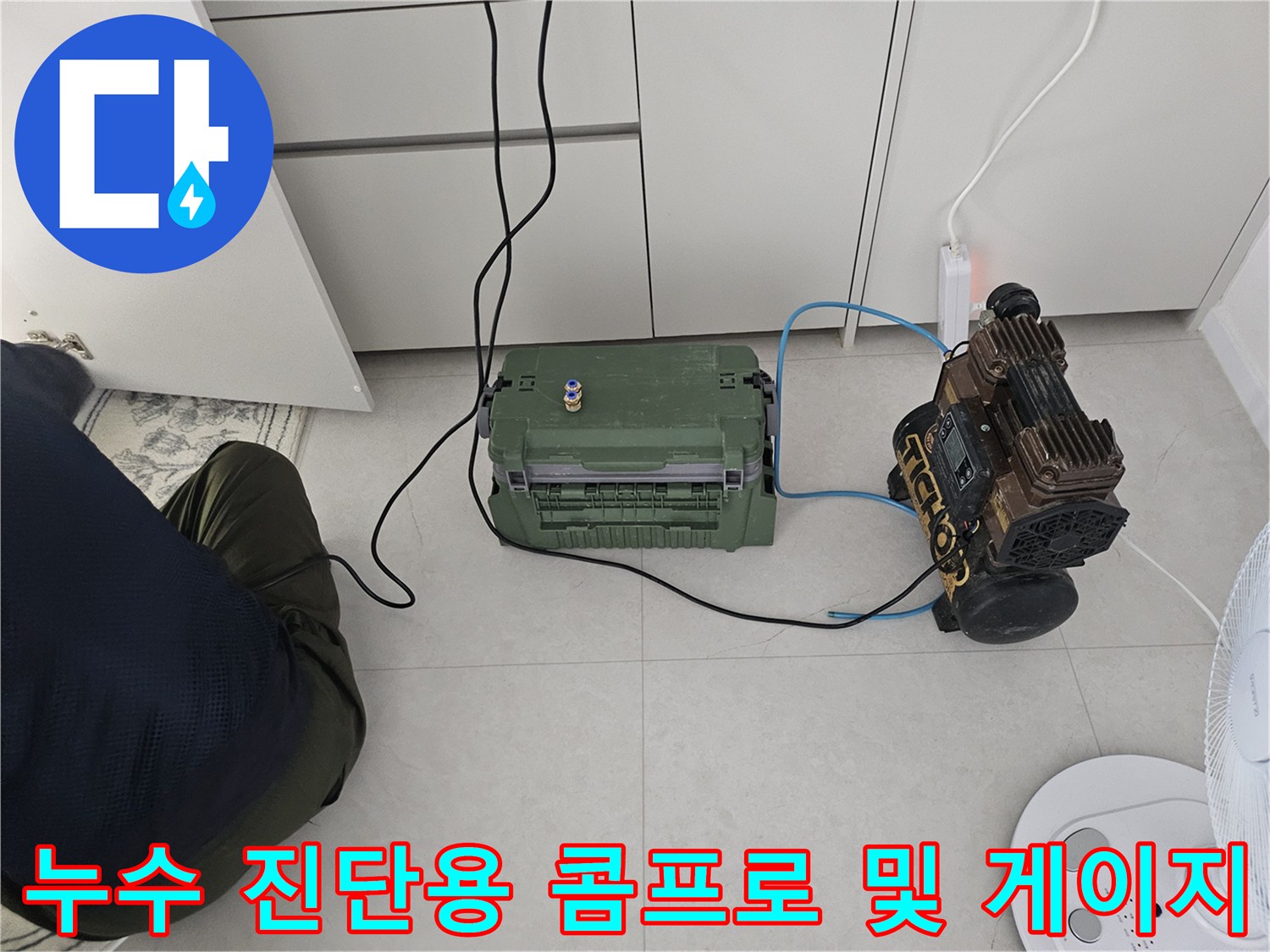 하수 배관 점검을 위해 준비된 공기 압축기와 압력계