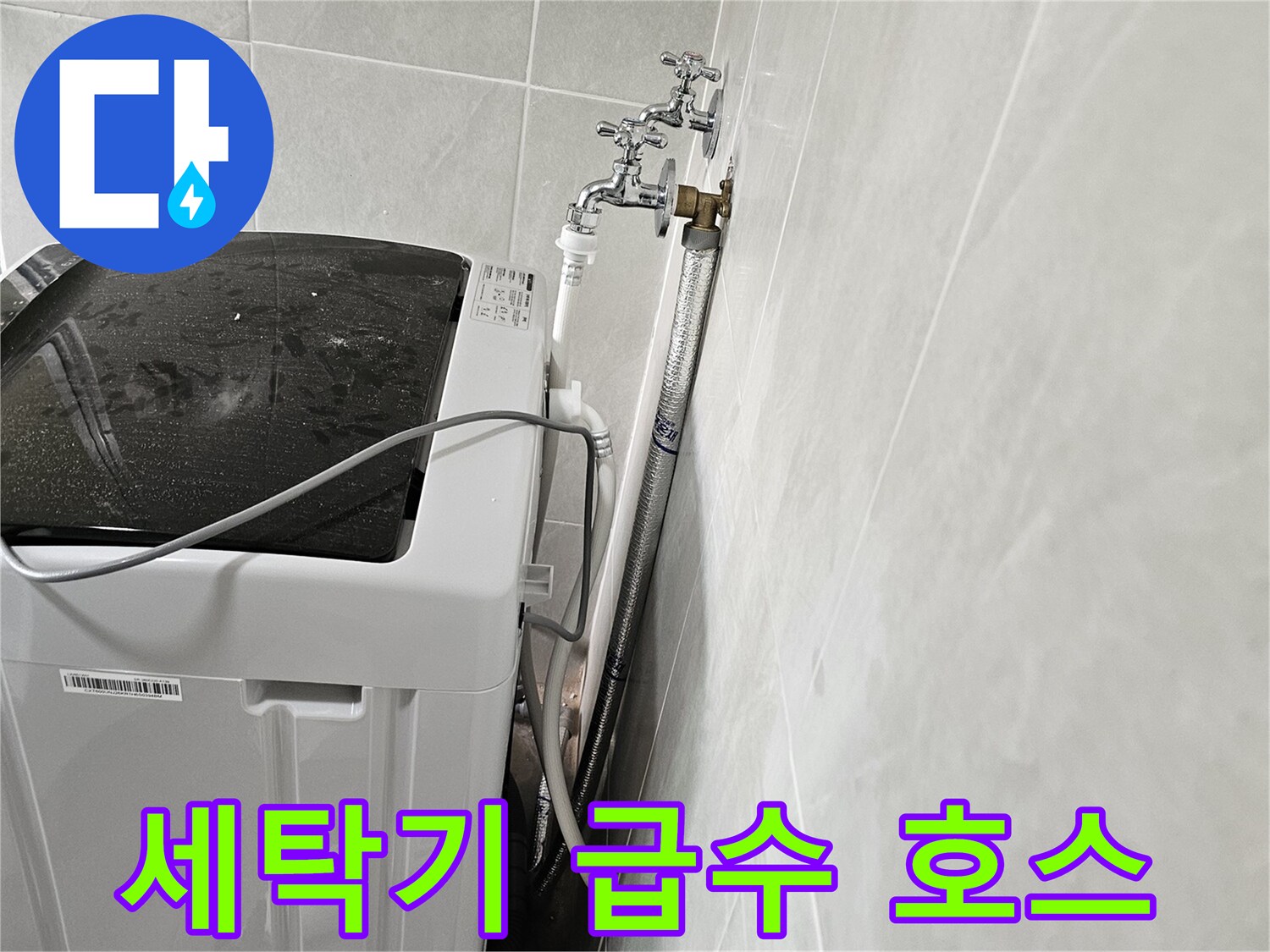 세탁실 벽면 수전과 연결된 흰색 급수 호스