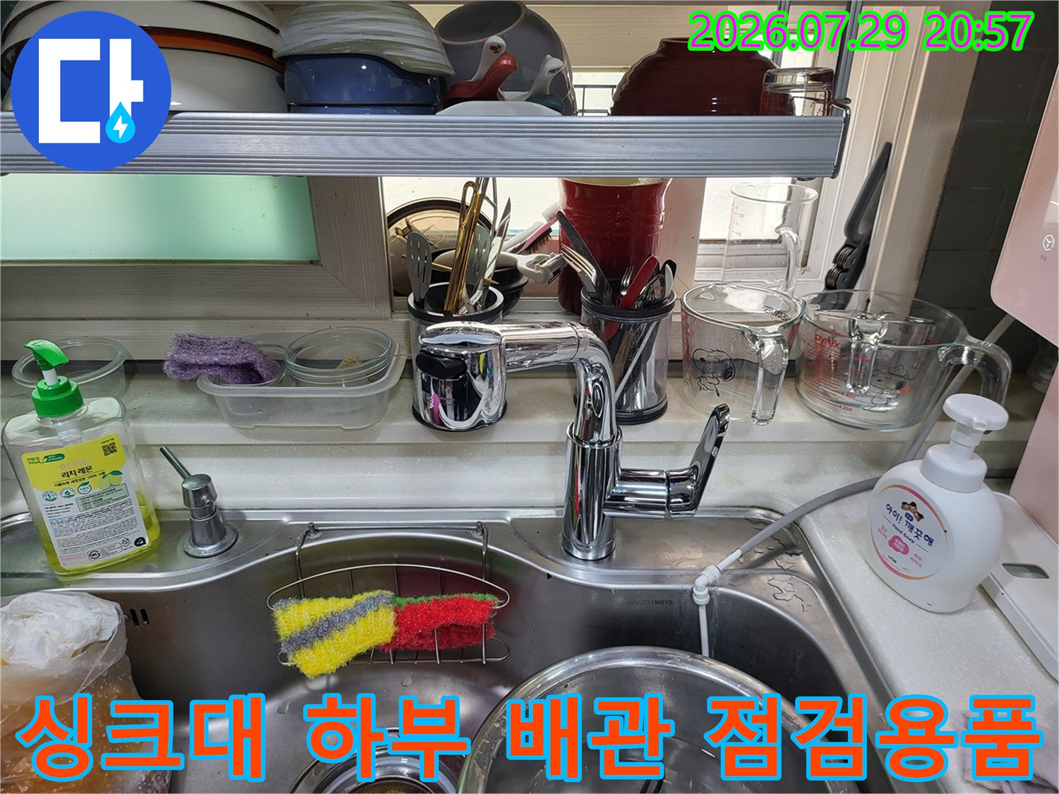 세척 도구와 수전 주변의 싱크대 아래쪽 공간 모습