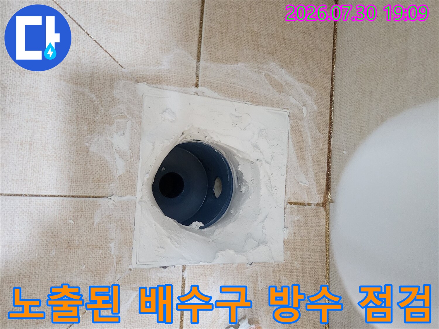 타일 철거 후 노출된 하부 구조와 배수 구역의 상태를 촬영한 모습