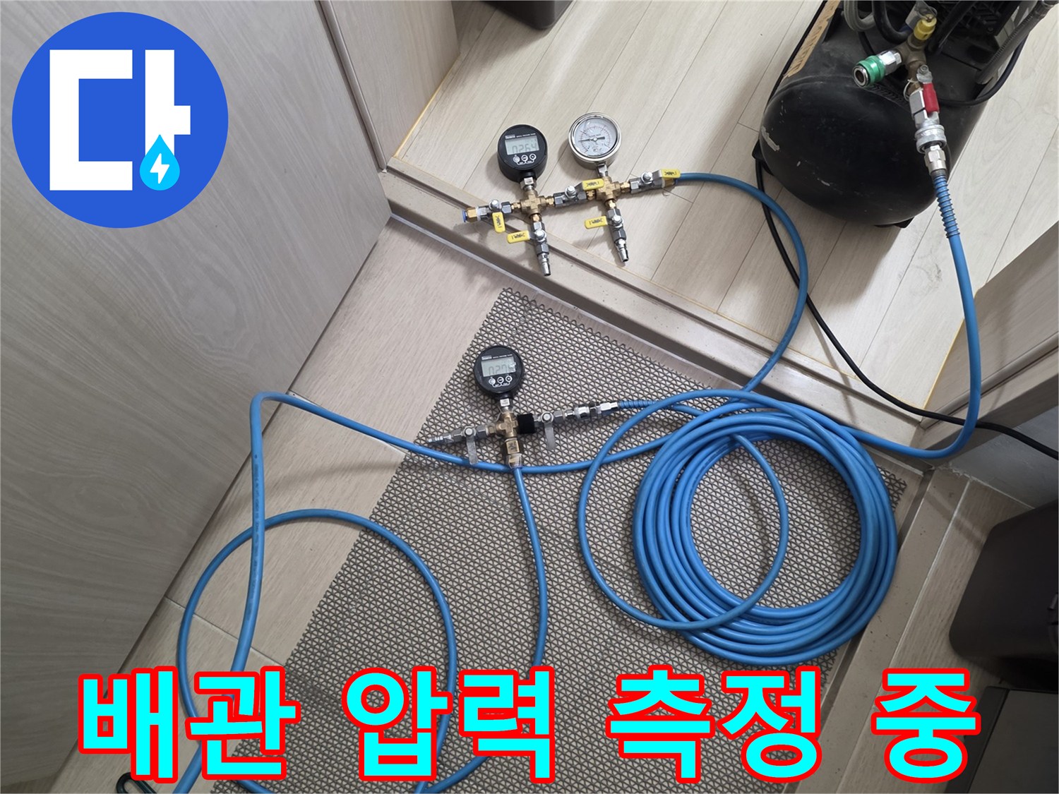 바닥에 설치된 공압 게이지와 연결된 호스 및 밸브 부품
