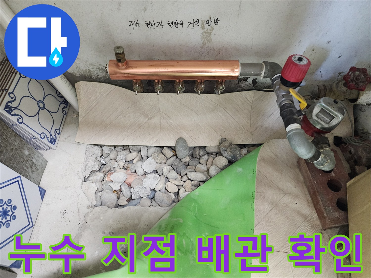 화장실 바닥 굴착 부위의 배관 연결 상태와 압력 장비를 보여주는 사진입니다.