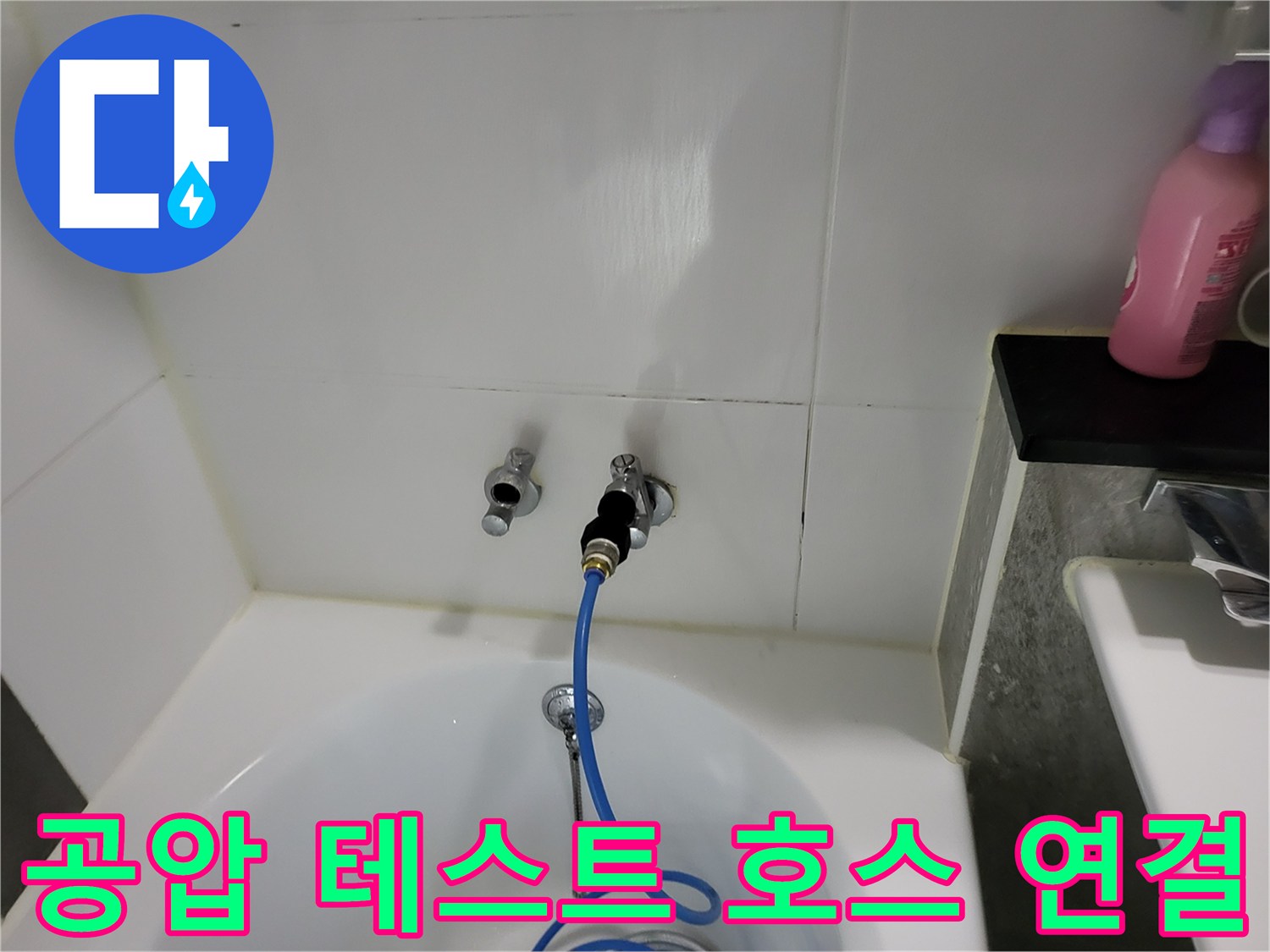 욕실 벽면 배관 부속-테스트용 블루 호스가 연결된 사진입니다.